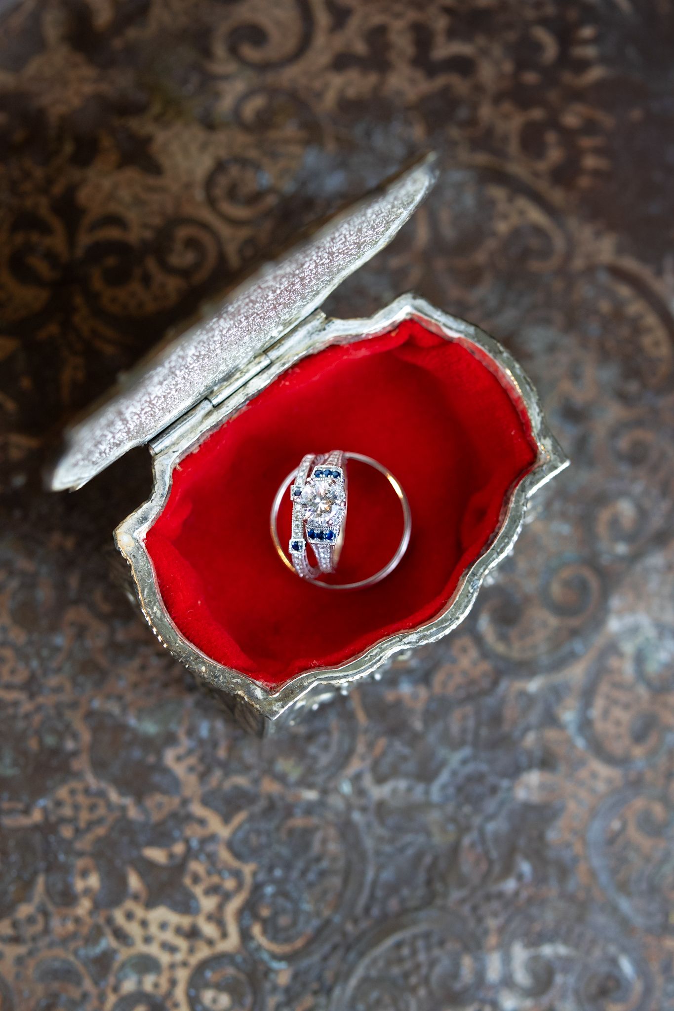 Editorial portrait of blue sapphire ring at Ritz Carlton venue, documented by a luxury Chicago wedding photographer for the bride and groom.