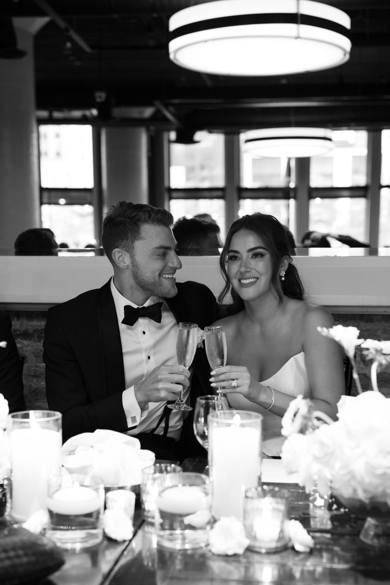 Bride and groom toasting inside River Roast Chicago wedding venue, captured by Chicago luxury wedding photographer.