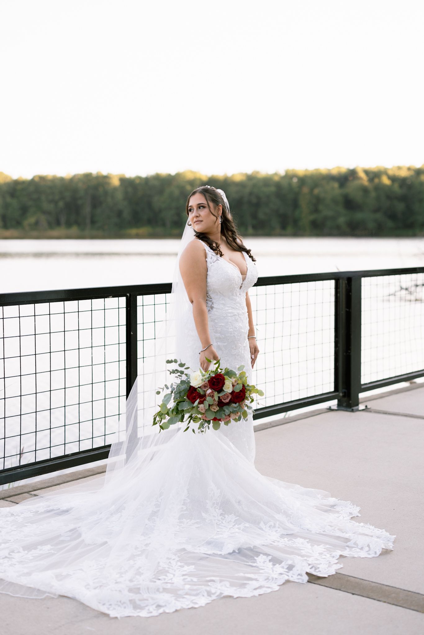 Bride elegantly posed with bouquet in her white dress during the reception, beautifully captured by a luxury Chicago wedding photographer.