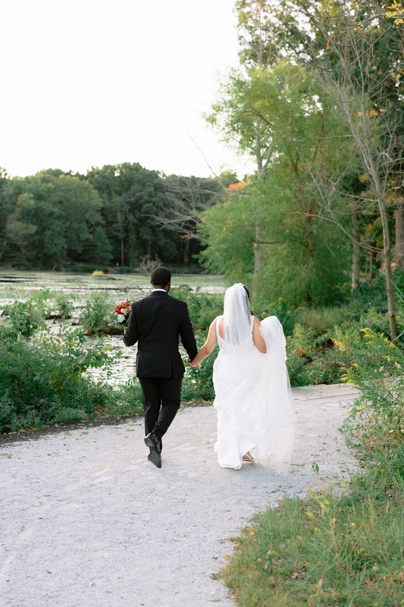 Bride and groom walking outdoors at Allure on the Lake in Chesterton, Indiana, captured by Chicago luxury wedding photographer candid style.