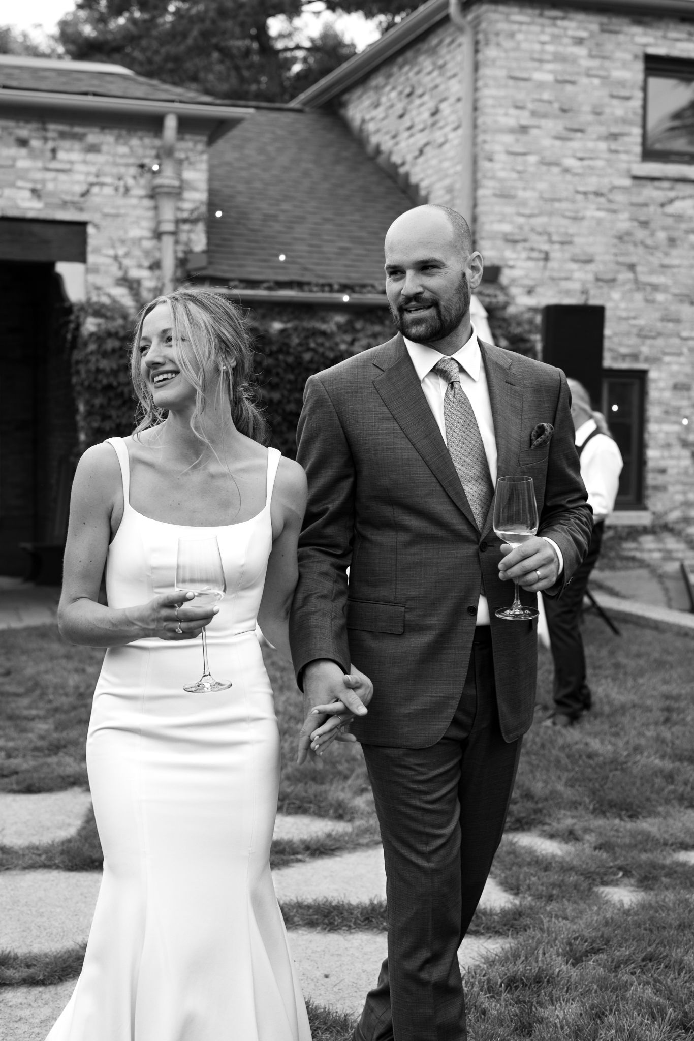 Candid photo of bride and groom holding cocktails, captured by a luxury Chicago wedding photographer specializing in documentary photos.