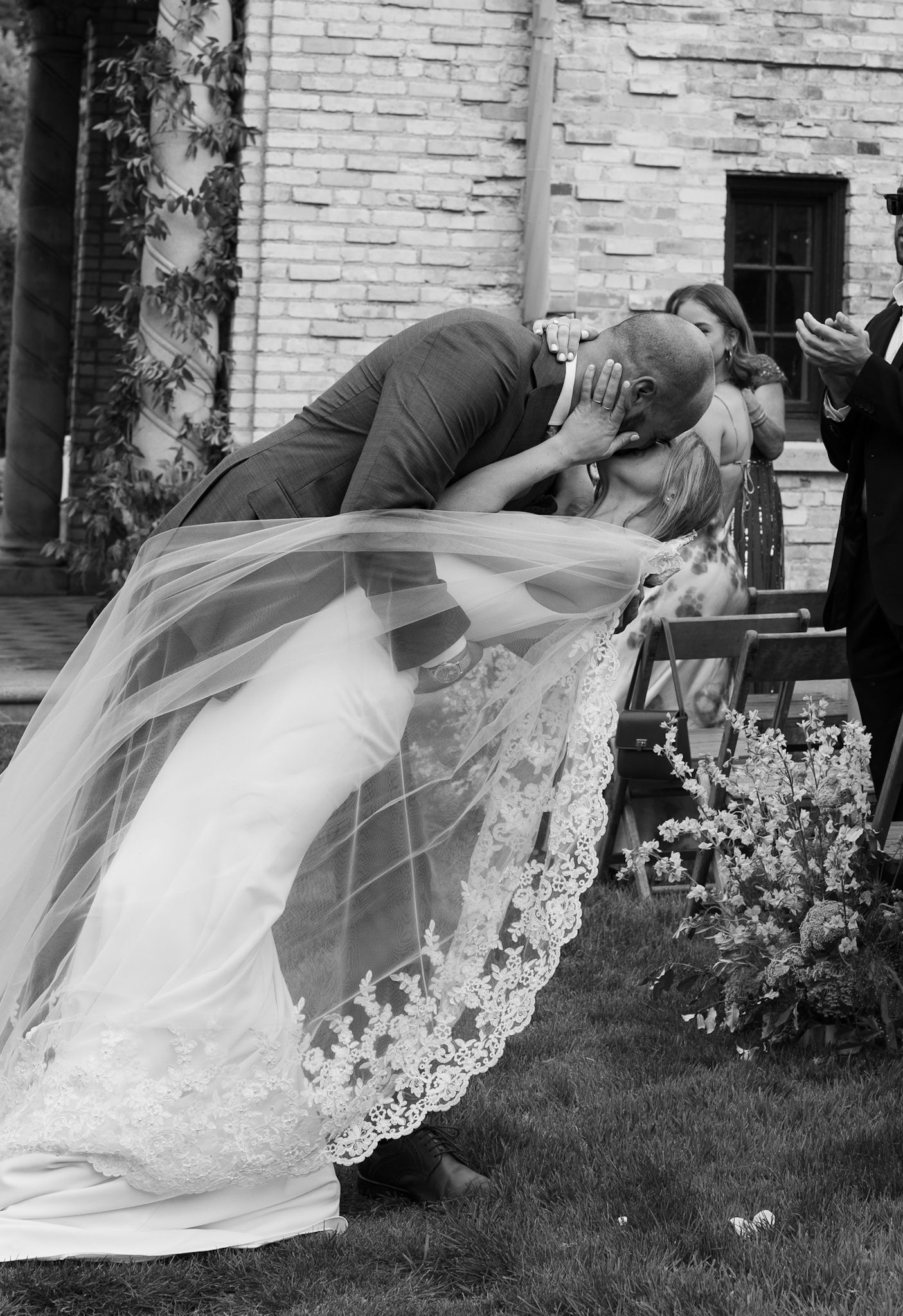 Bride and groom’s first kiss down the aisle in Steven Khalil veil, captured by luxury Chicago wedding photographer in documentary style.