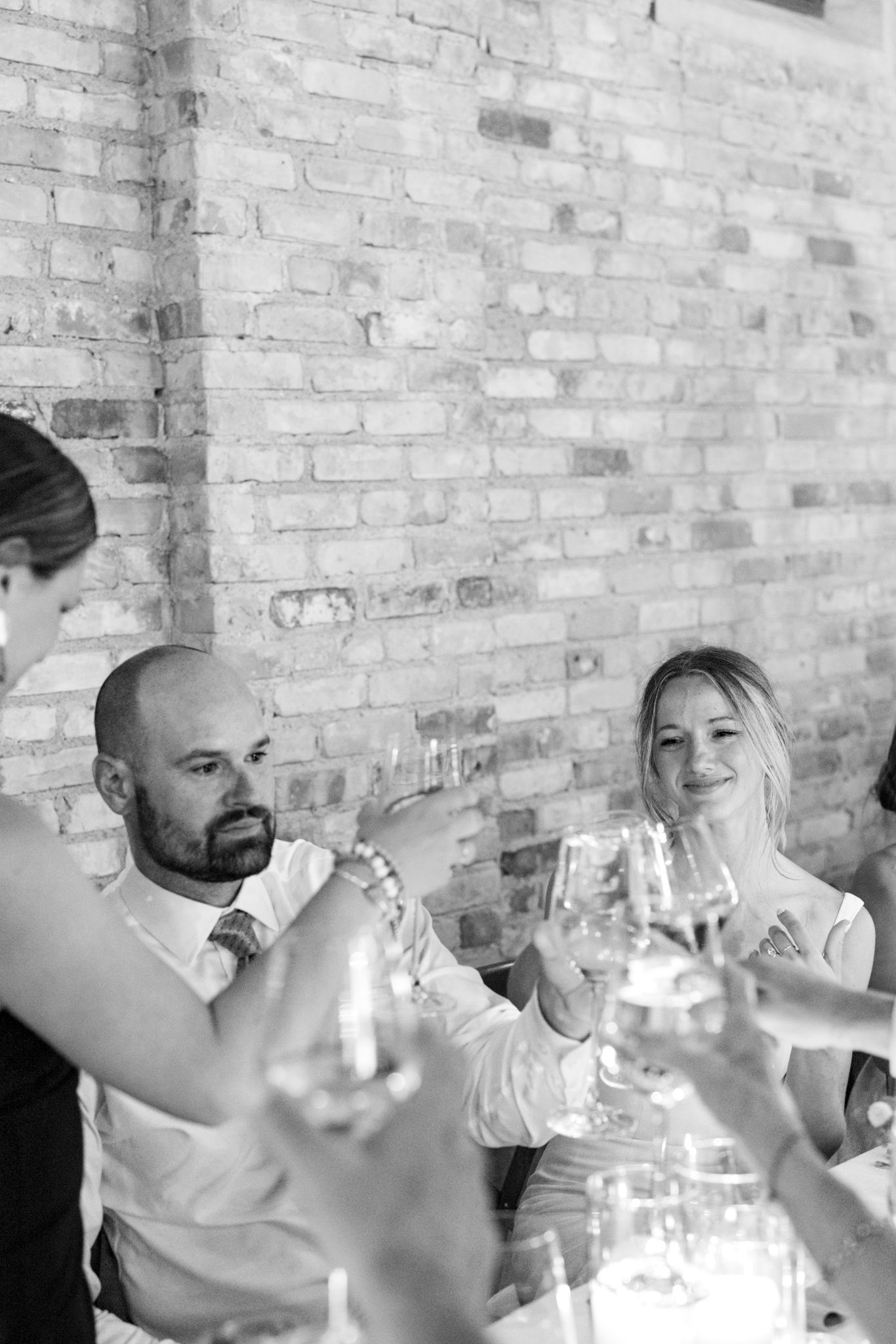 Candid bride and groom toasting guests, captured in a candid documentary and editorial style by a luxury Chicago wedding photographer.