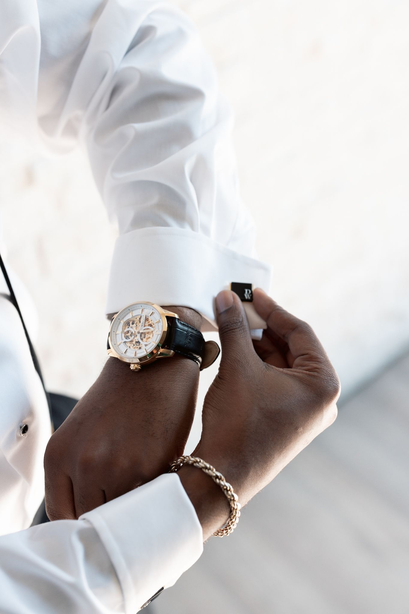Fine art portrait of groom with watch, captured by a luxury Chicago wedding photographer specializing in documentary and editorial wedding.