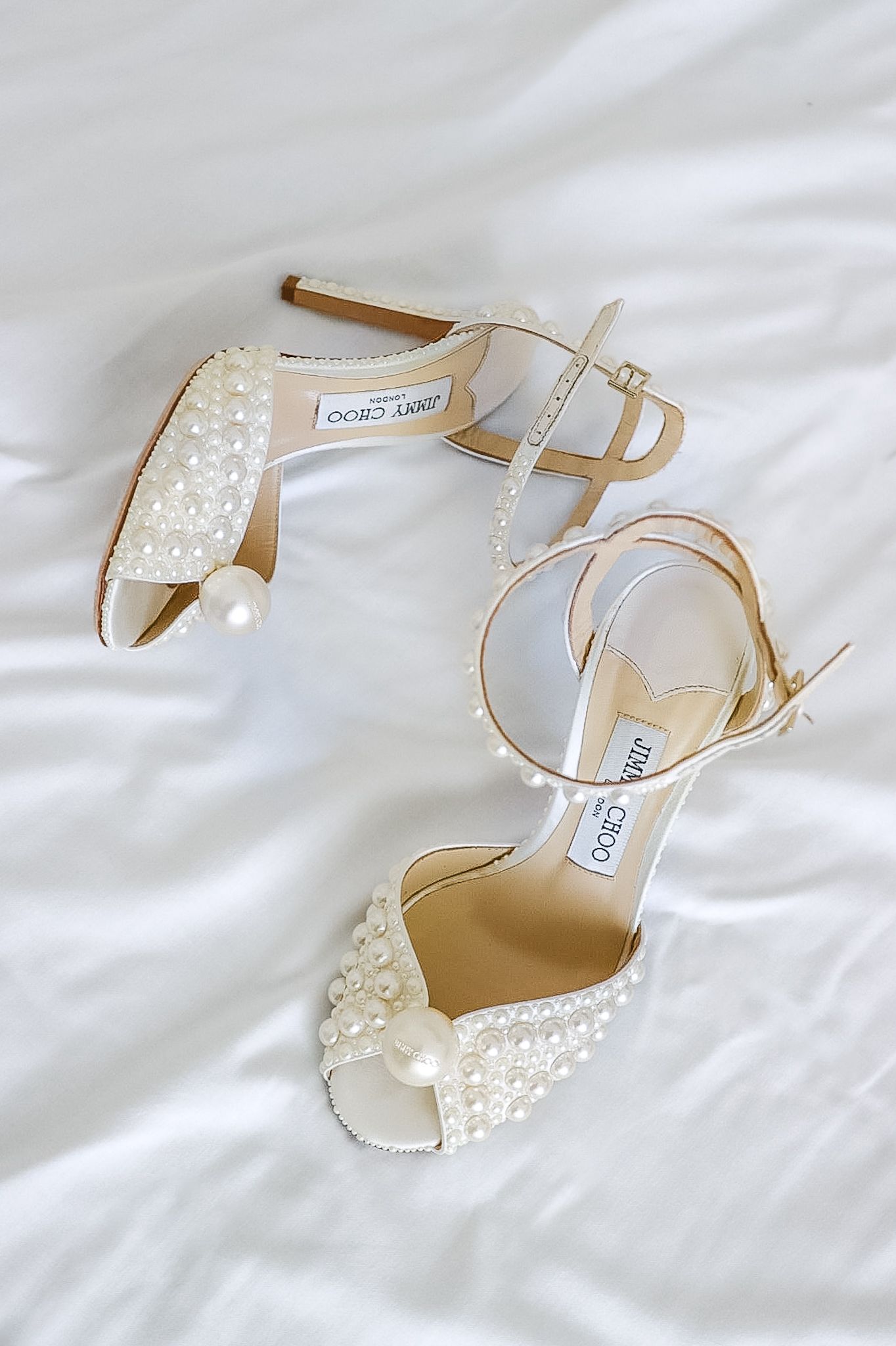Pearl white Jimmy Choo Sacora 100 heels featured in wedding day preparations, photographed by Chicago and destination wedding photographer.
