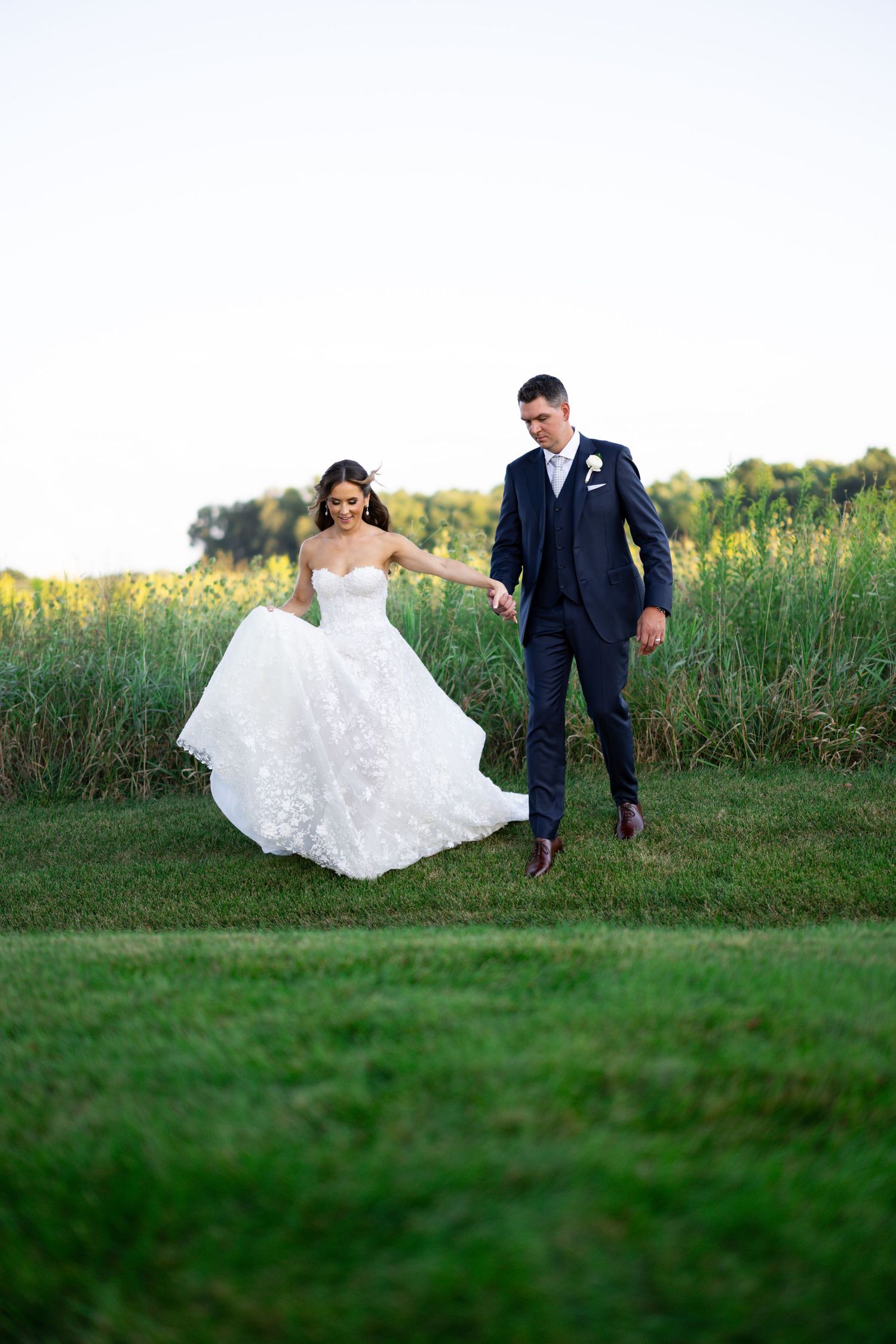 Bride and groom portrait at sunset in downtown Chicago. Luxury Chicago wedding couple portrait during golden hour having a candid moment.
