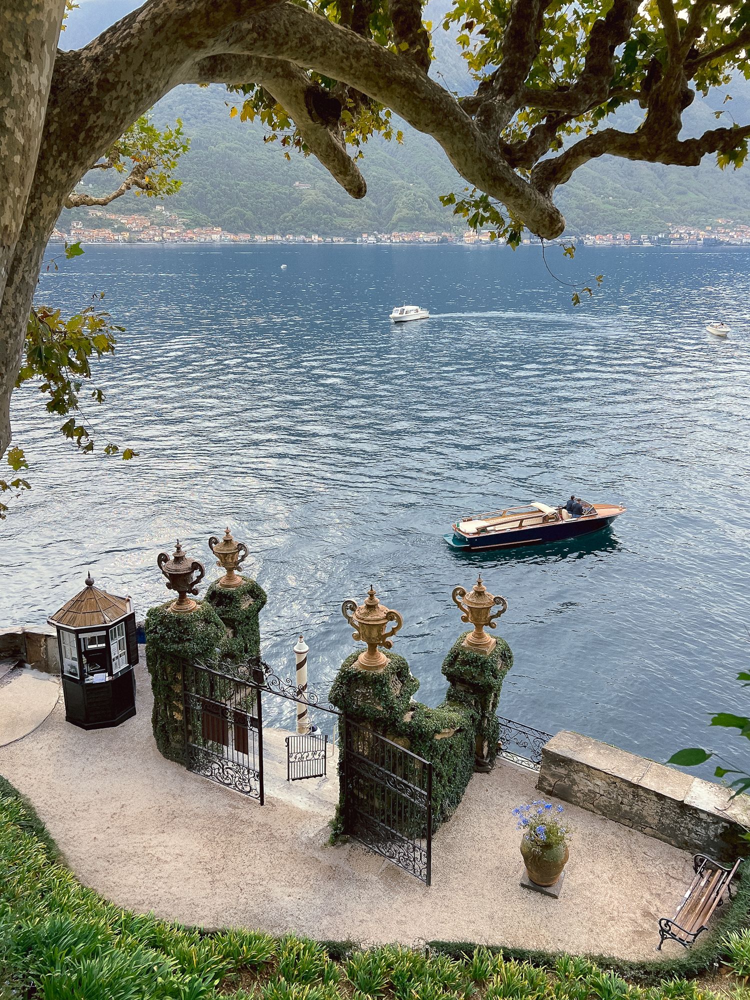 Romantic Lake Como boat with Villa Balbianello and crystal blue water, captured by destination wedding photographer.