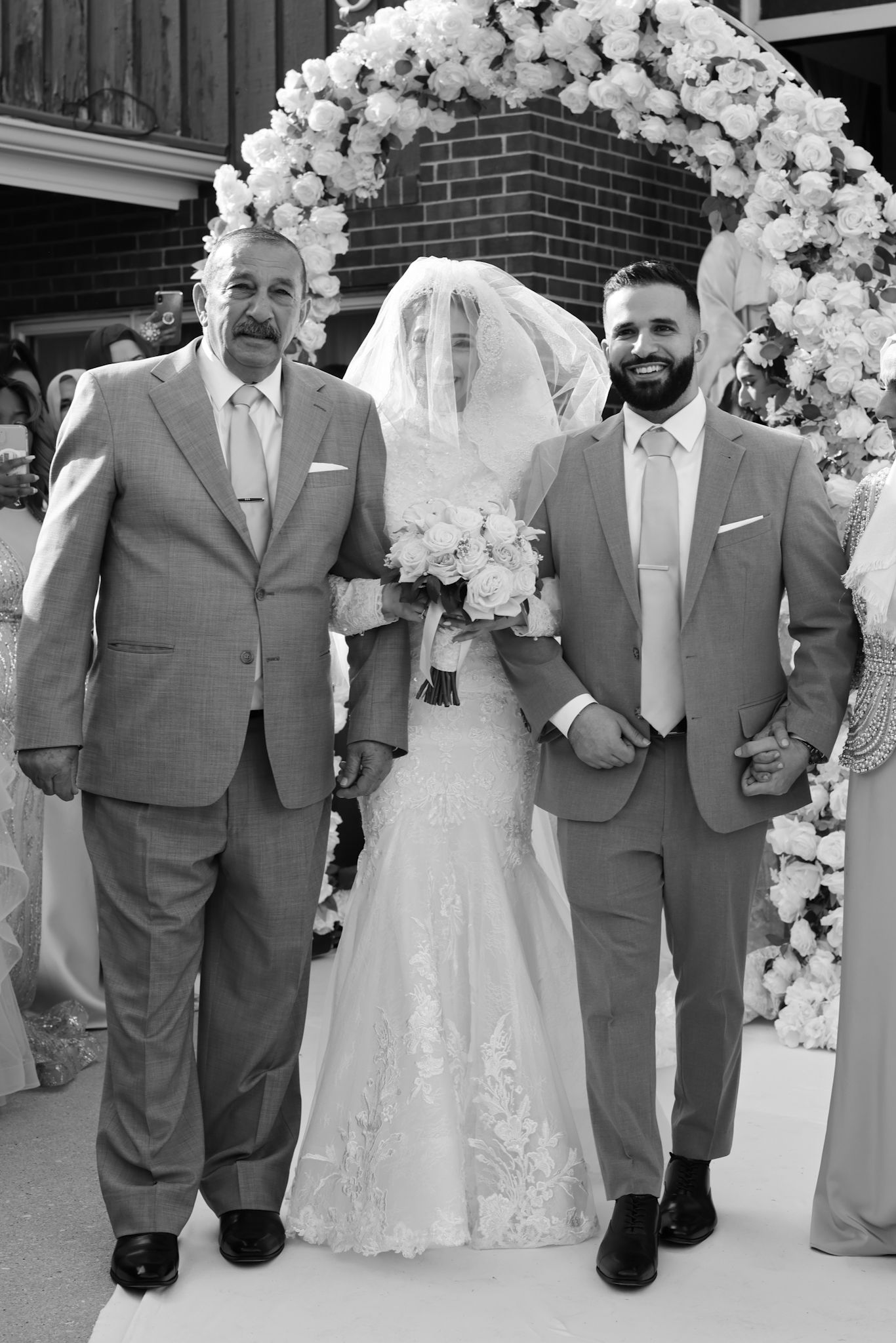 A luxury Chicago wedding photographer captures the bride's emotional walk with her father. This is documentary, editorial style photography.