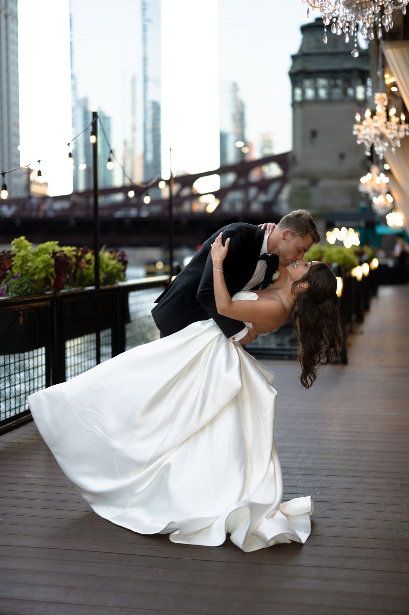 Elegant River Roast wedding photography in downtown Chicago, featuring the bride and groom’s smiling at each other on the outdoor terrace.