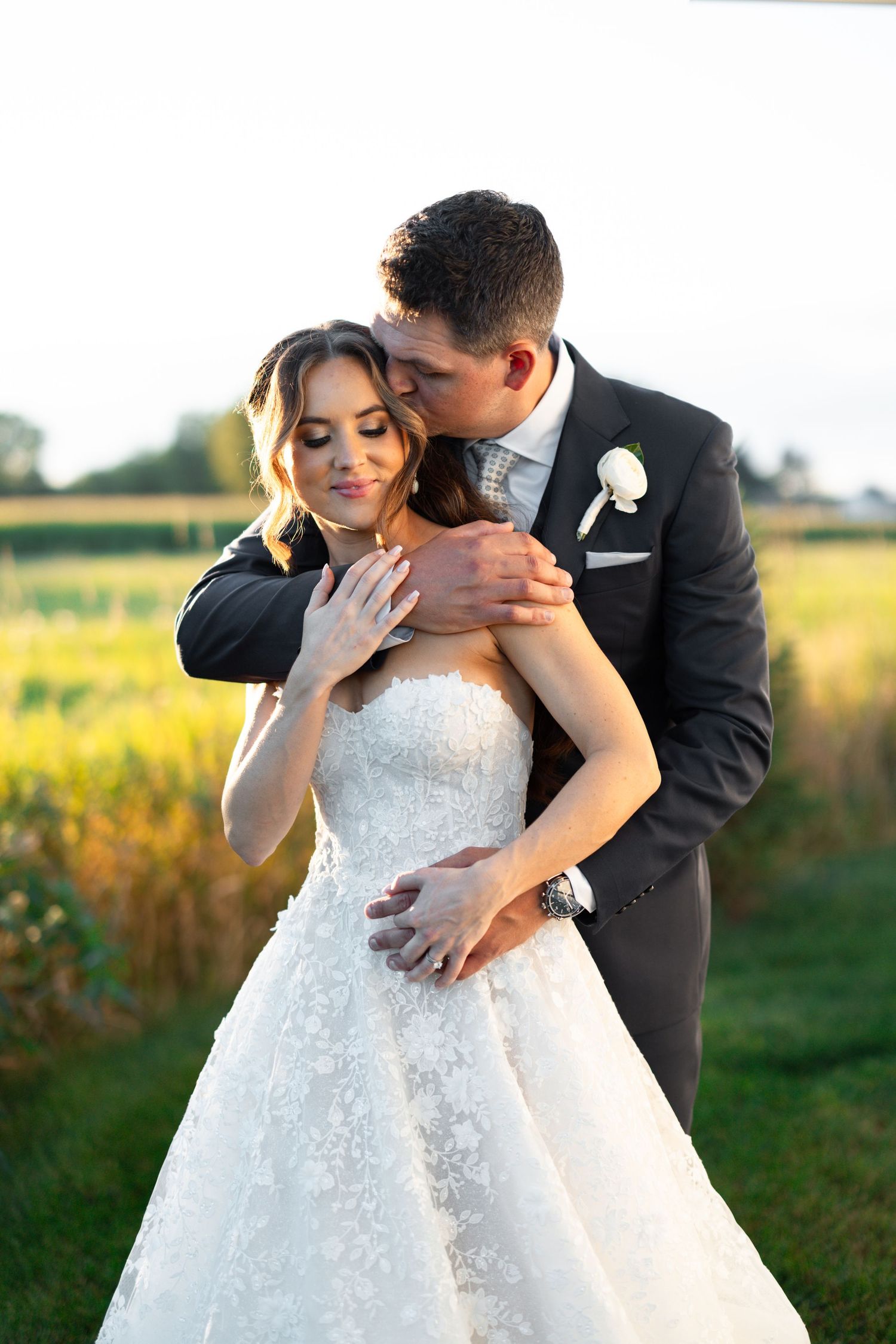Bride and groom portrait at sunset with glowing  views before their luxury barn wedding at etre farms in St. Joseph, Michigan.