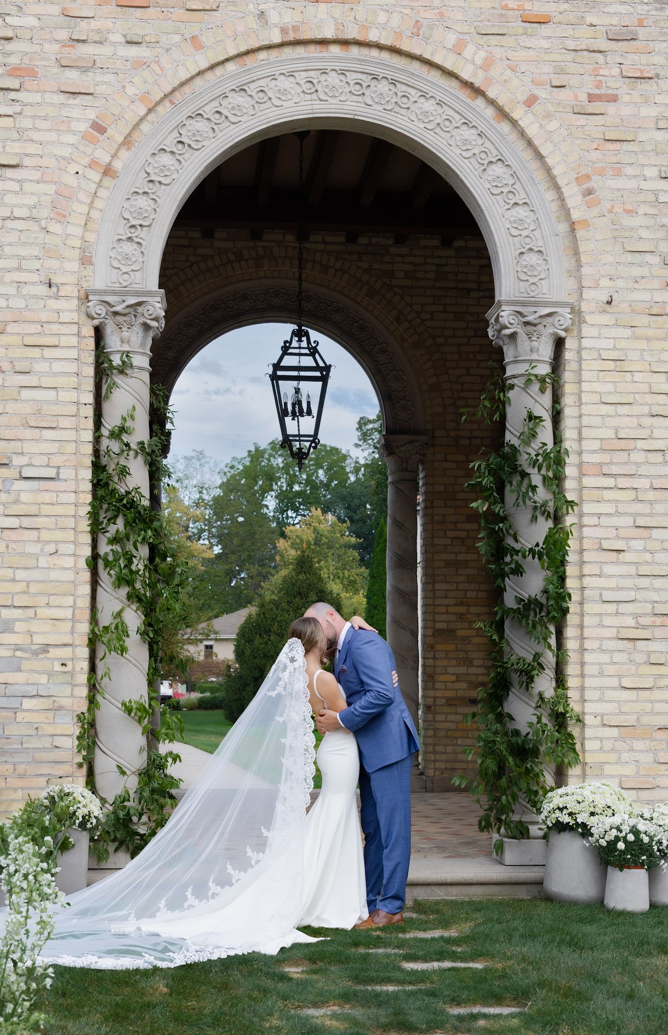 Bride and groom’s first kiss at Italian-style wedding venue, captured by luxury Chicago wedding photographer in editorial documentary style.