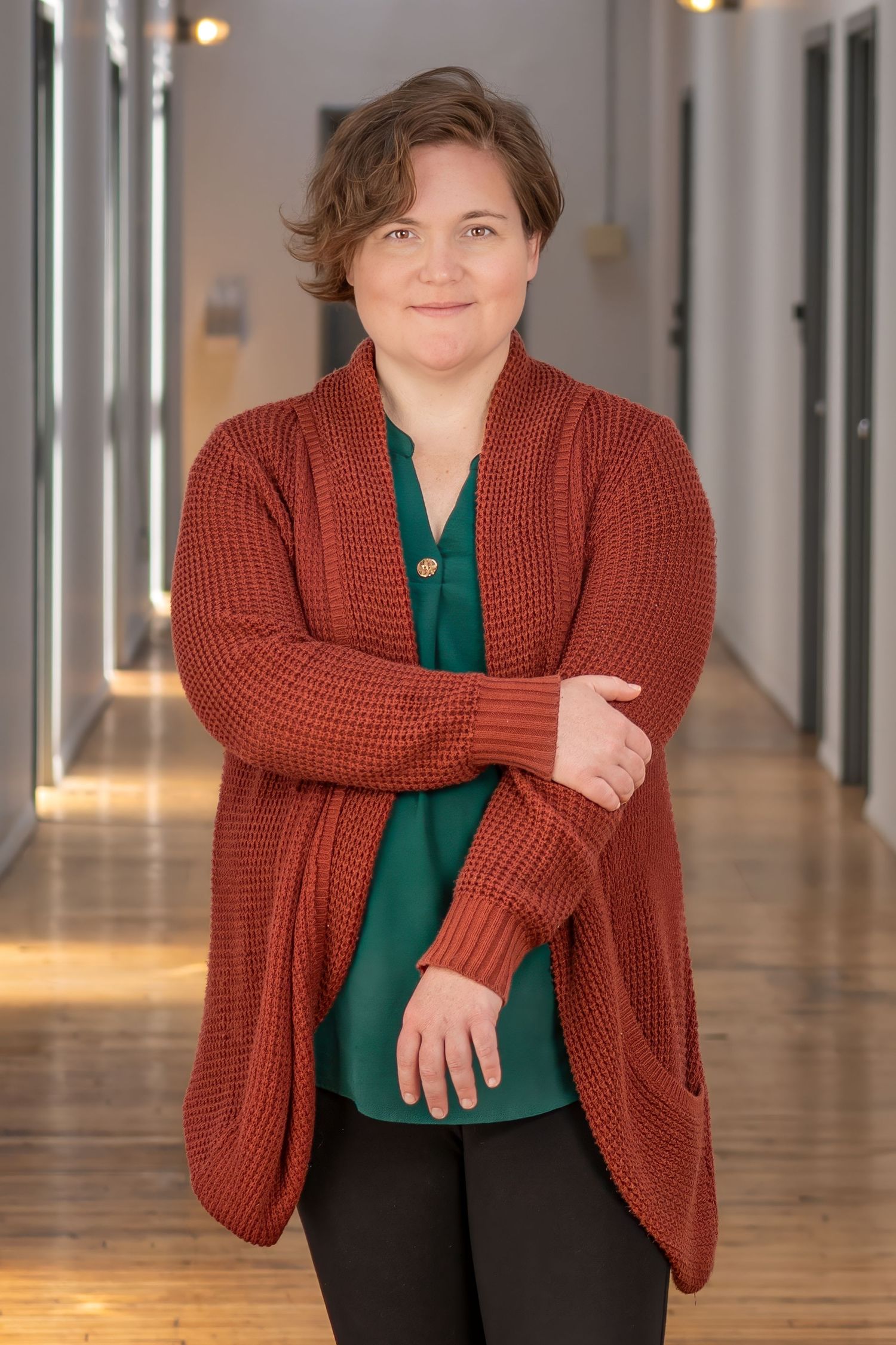 Personal branding portrait of a woman in a red cardigan
