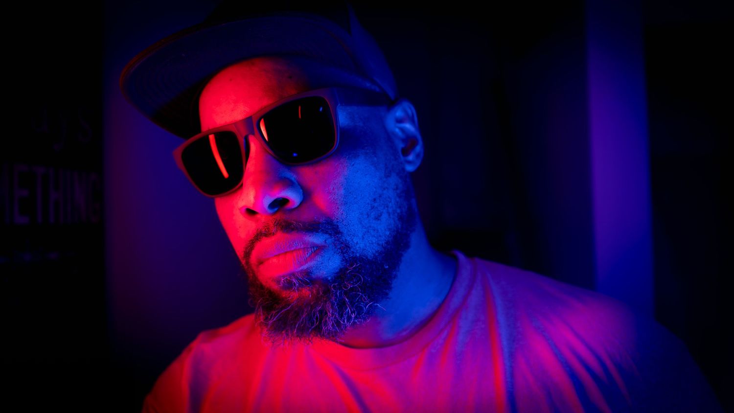 Creative portrait of Roman Warren in red and blue neon lighting