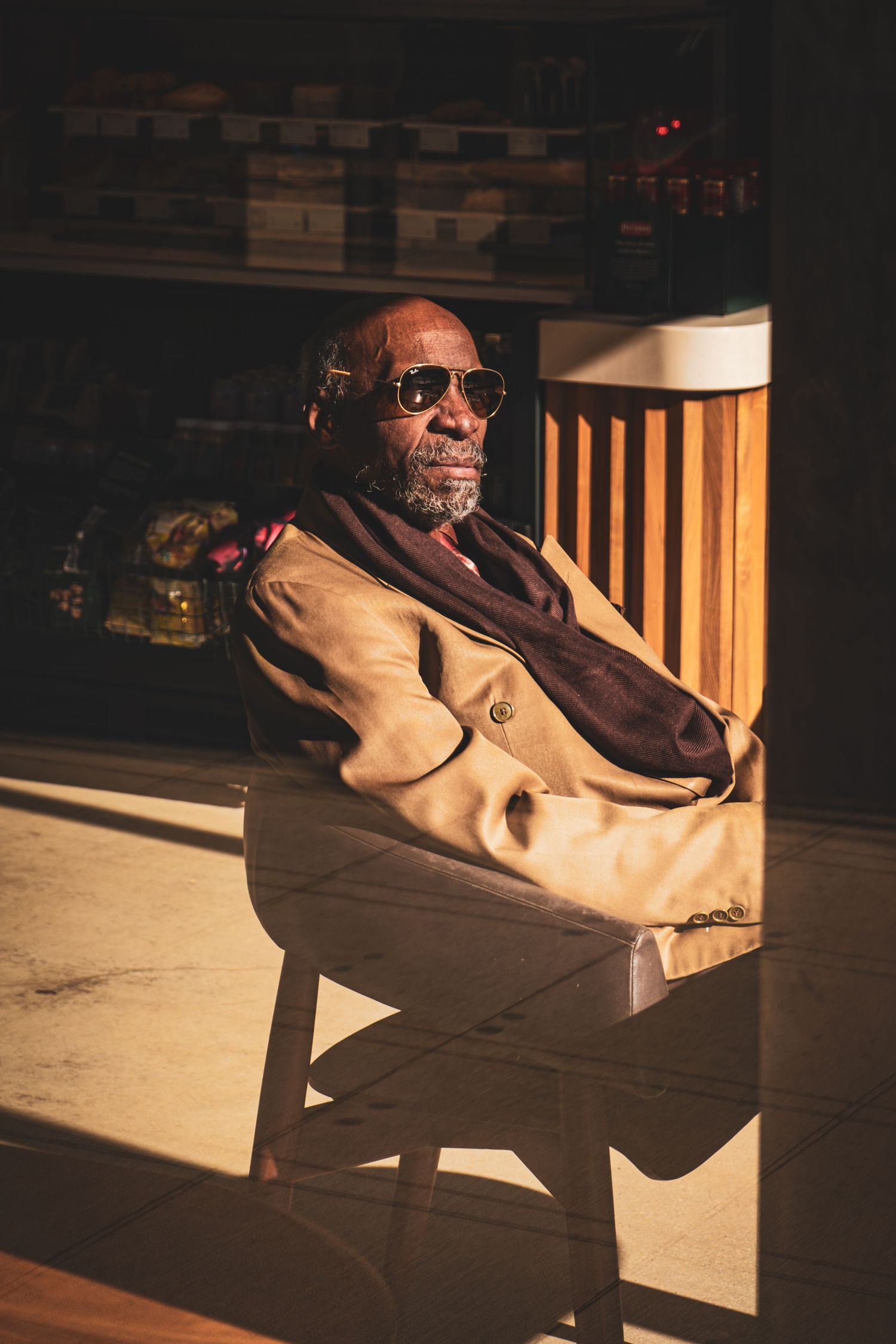 Moody low-light portrait of a man in warm window light