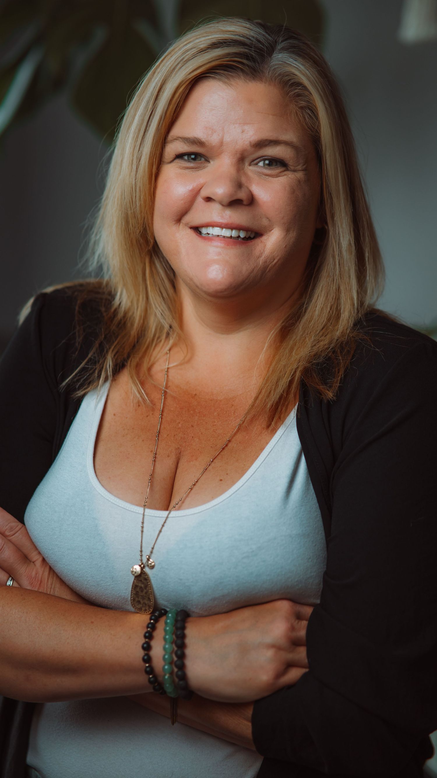 Professional headshot of a woman against a dark backdrop
