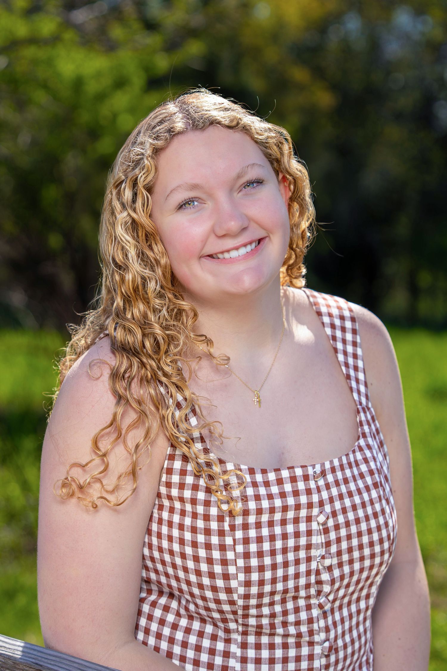 Woman sitting outside on a bench in a park
