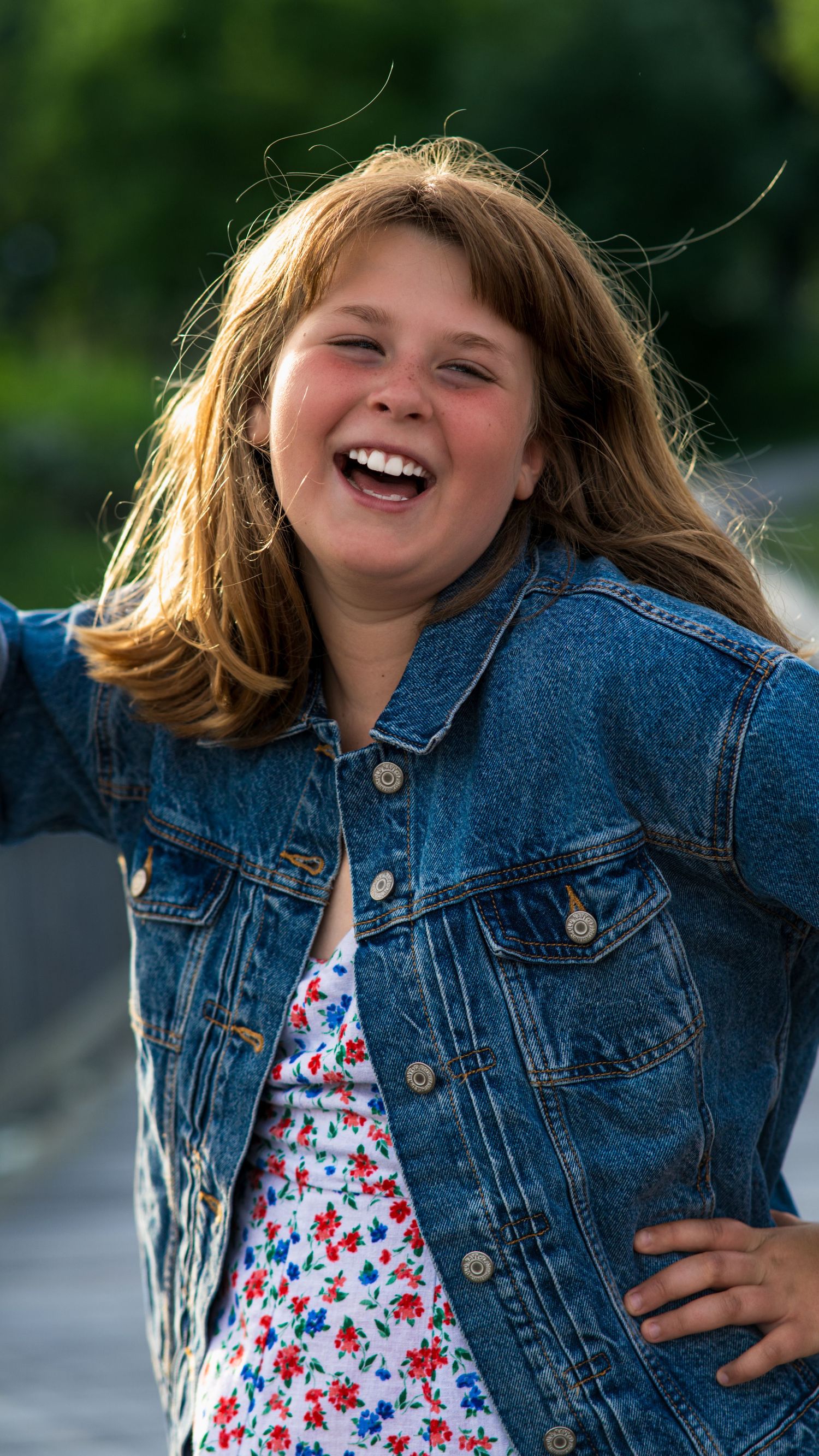 Candid photo of a girl laughing during an outdoor family session