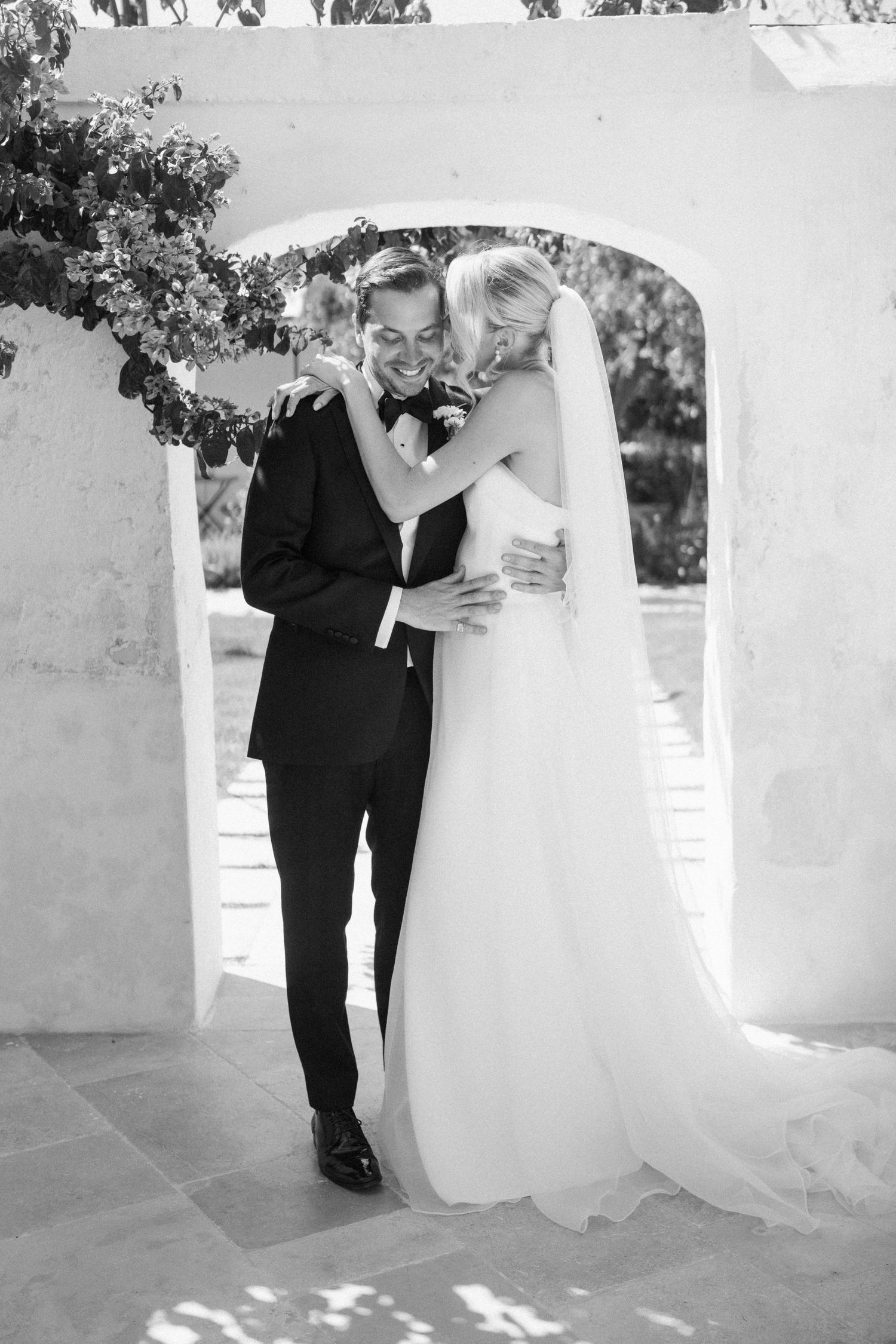 A romantic black and white wedding photoshoot sequence showing tender moments between a couple in formal attire.