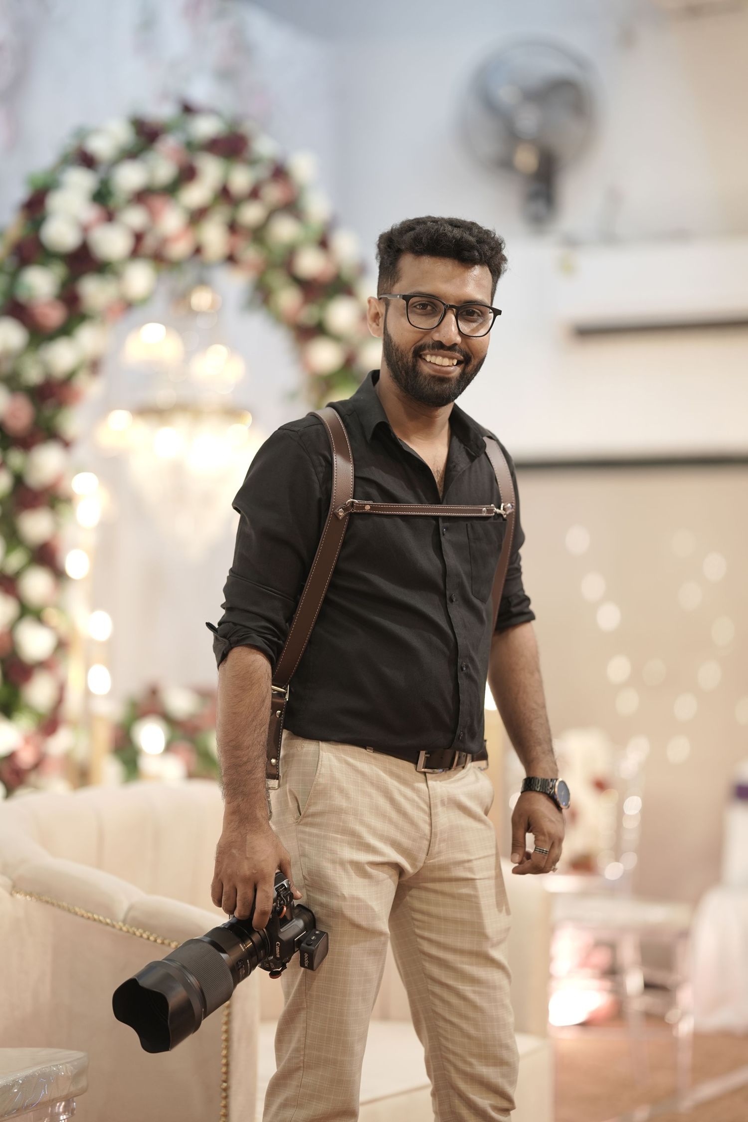 Wedding photographer holding a camera during a wedding photoshoot