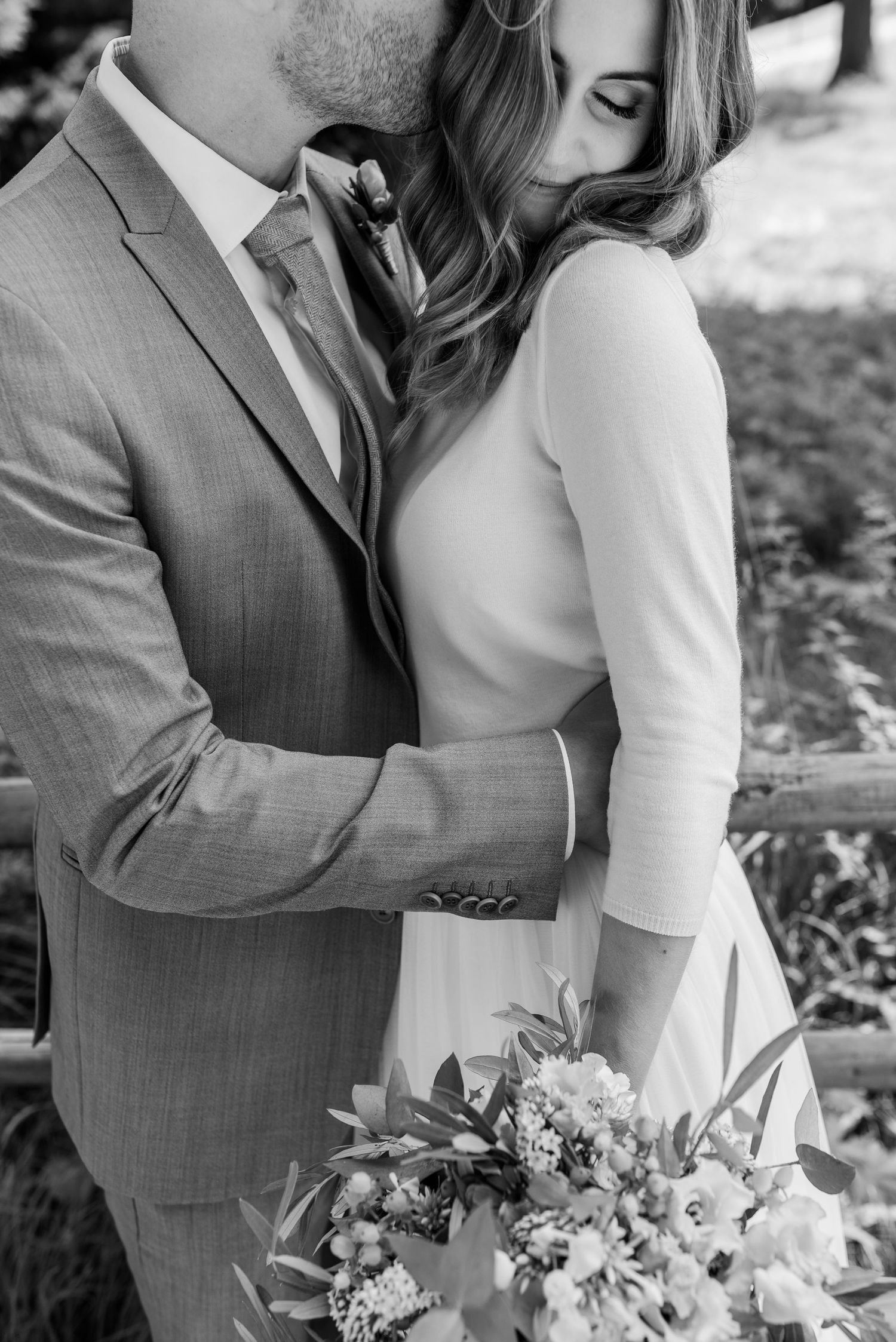Black and white wedding photo series showing romantic close-up moments between a couple with floral bouquet details.