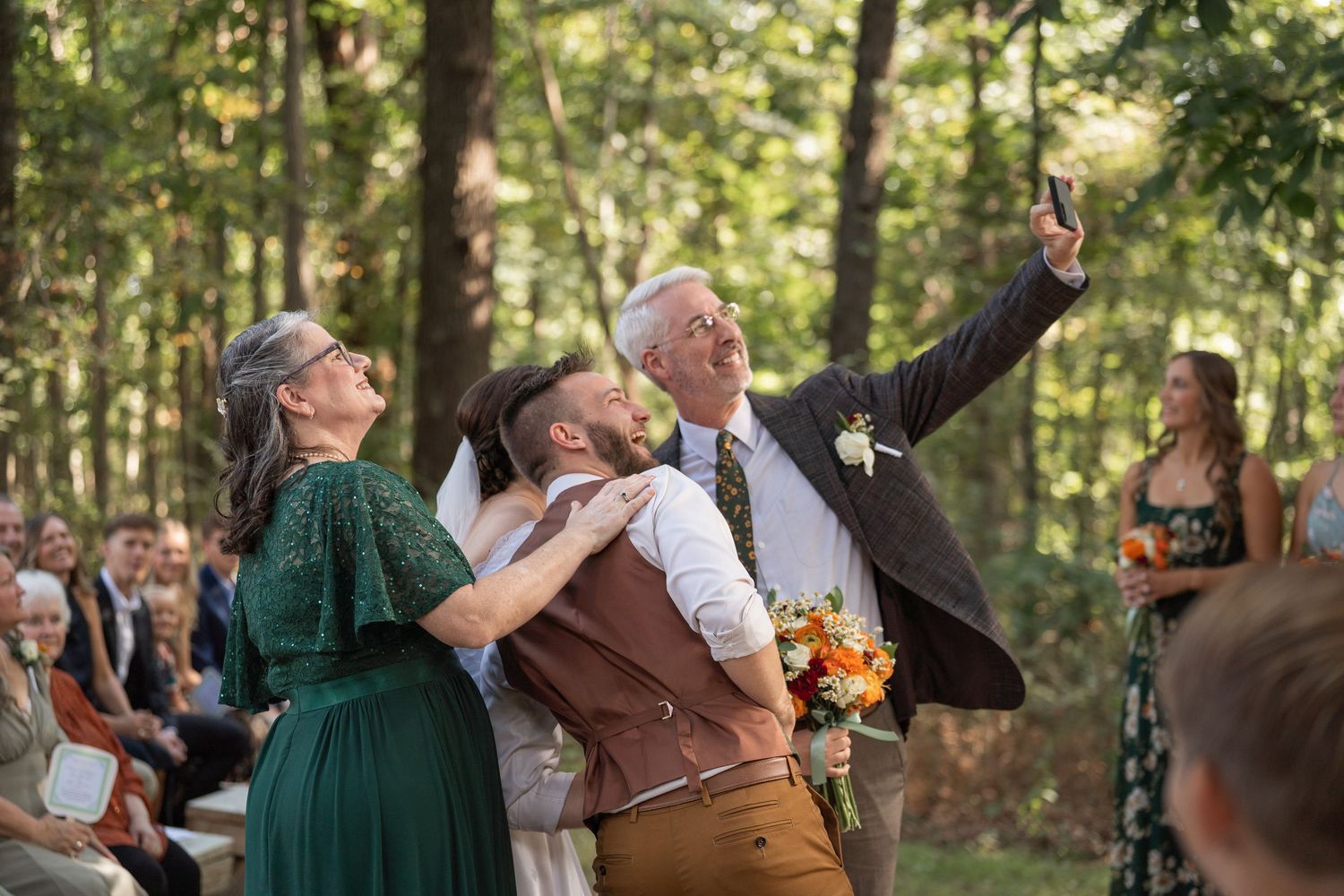 ©AnnaVonRiesenPhotography Wedding Photography | Color image of the FOB taking a selfie with bride, groom, and MOB during the ceremony.