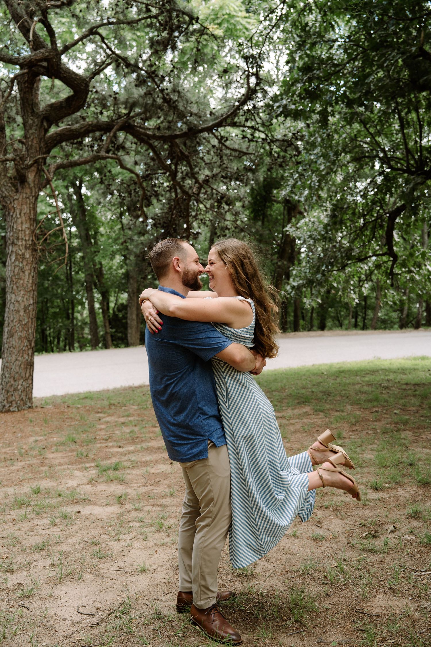 ©AnnaVonRiesenPhotography Engagement Photography | Color image of a couple spinning, the woman is being lifted by her fiancé.