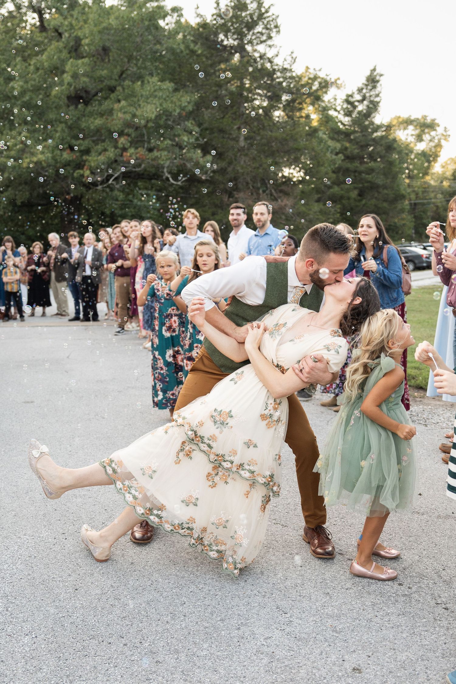 ©AnnaVonRiesenPhotography Wedding Photography | Color image of the bride & groom dipping and kissing during their bubble exit.