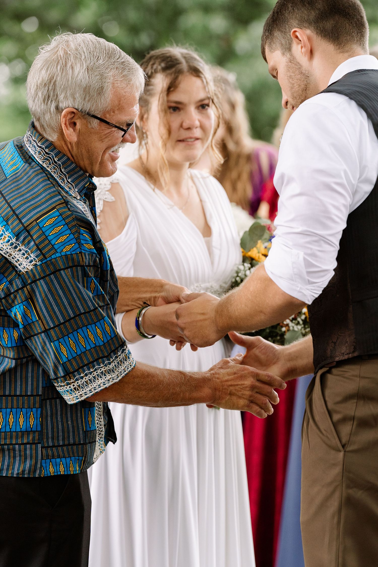 ©AnnaVonRiesenPhotography Wedding Photography | Color image of the bride's father passing her off to her groom.