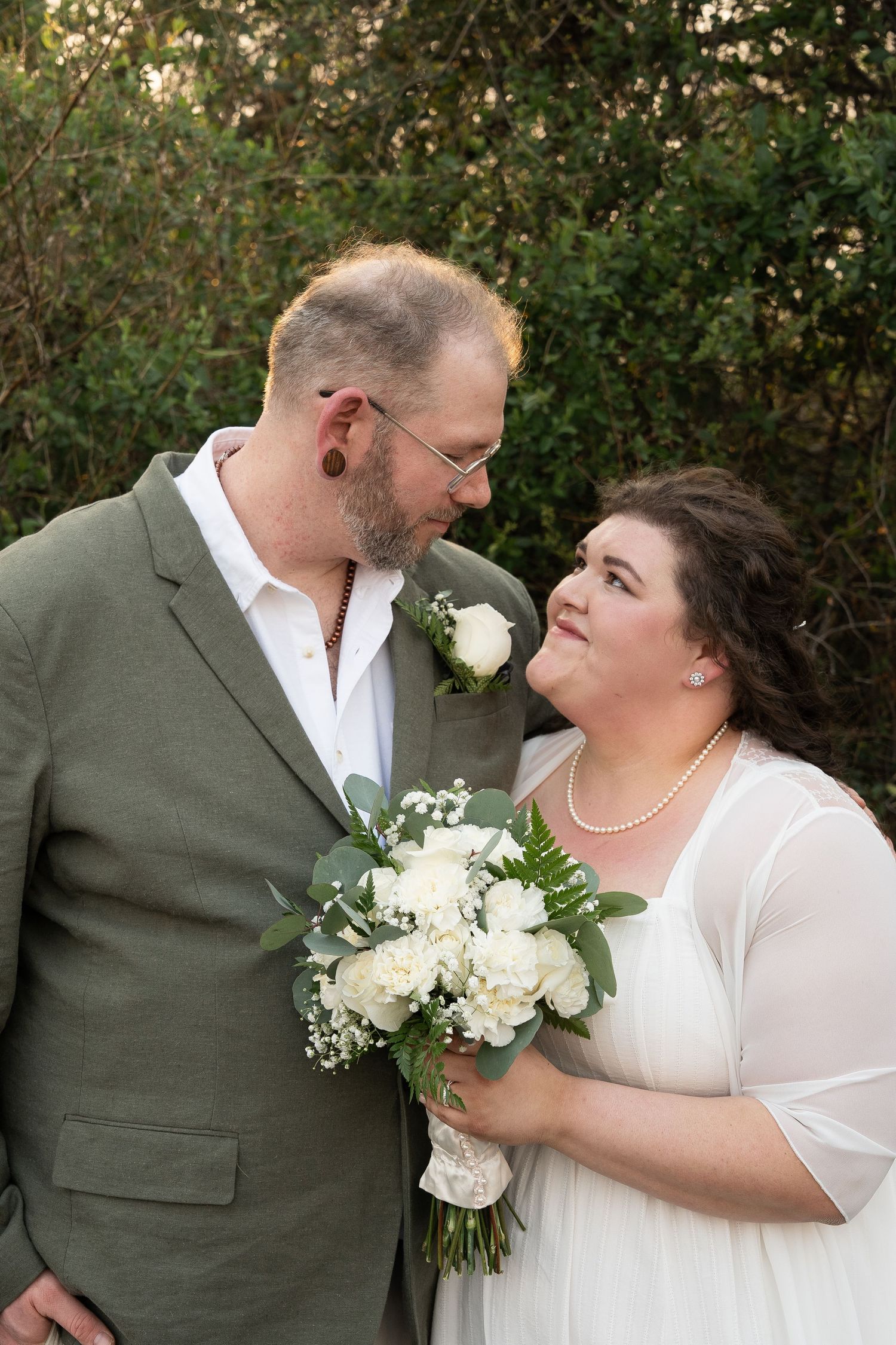 ©AnnaVonRiesenPhotography Wedding Photography | Color image of a bride & groom smiling at each other.