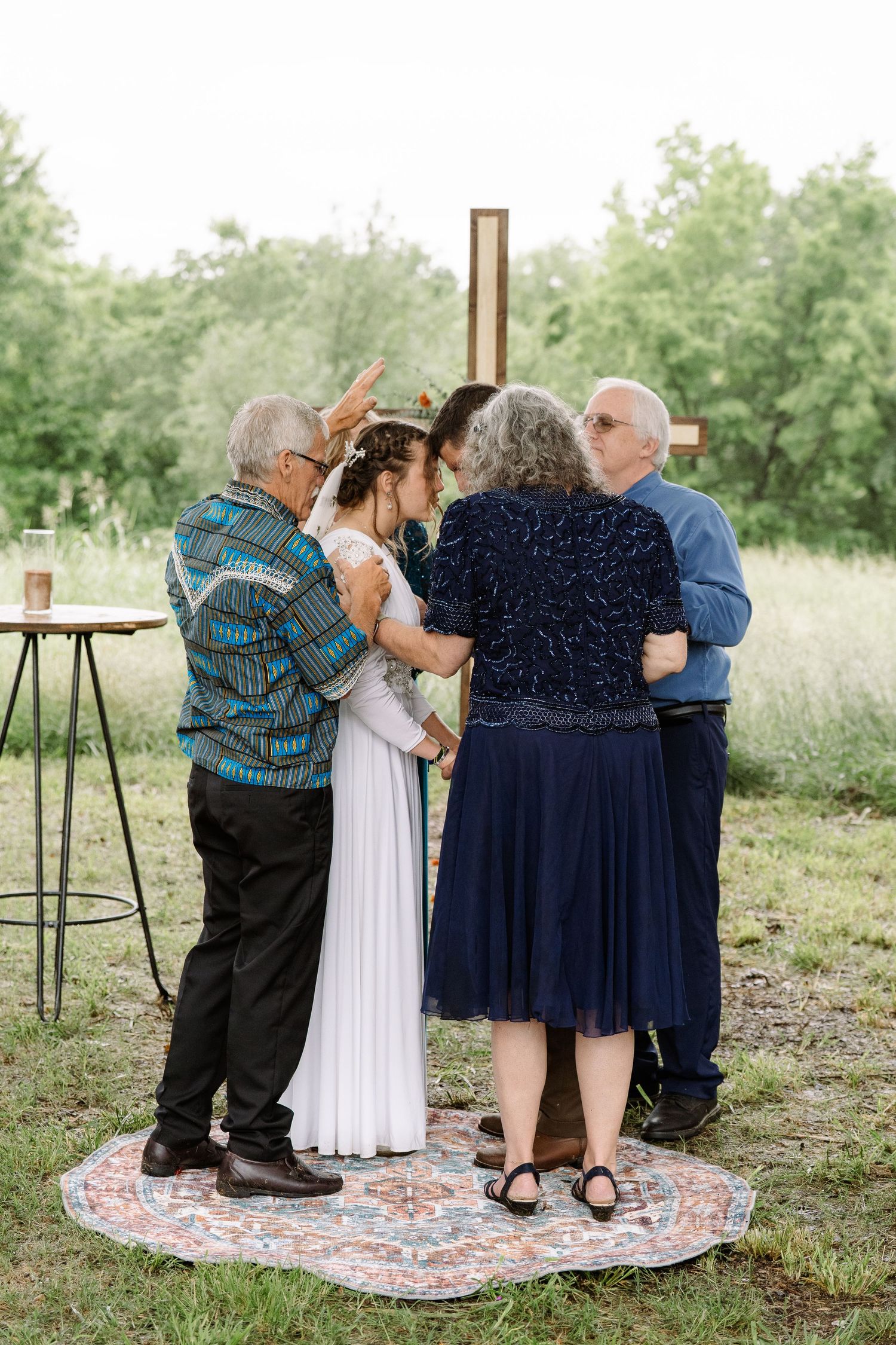 ©AnnaVonRiesenPhotography Wedding Photography | Color image of the parents praying over the bride & groom at the altar.