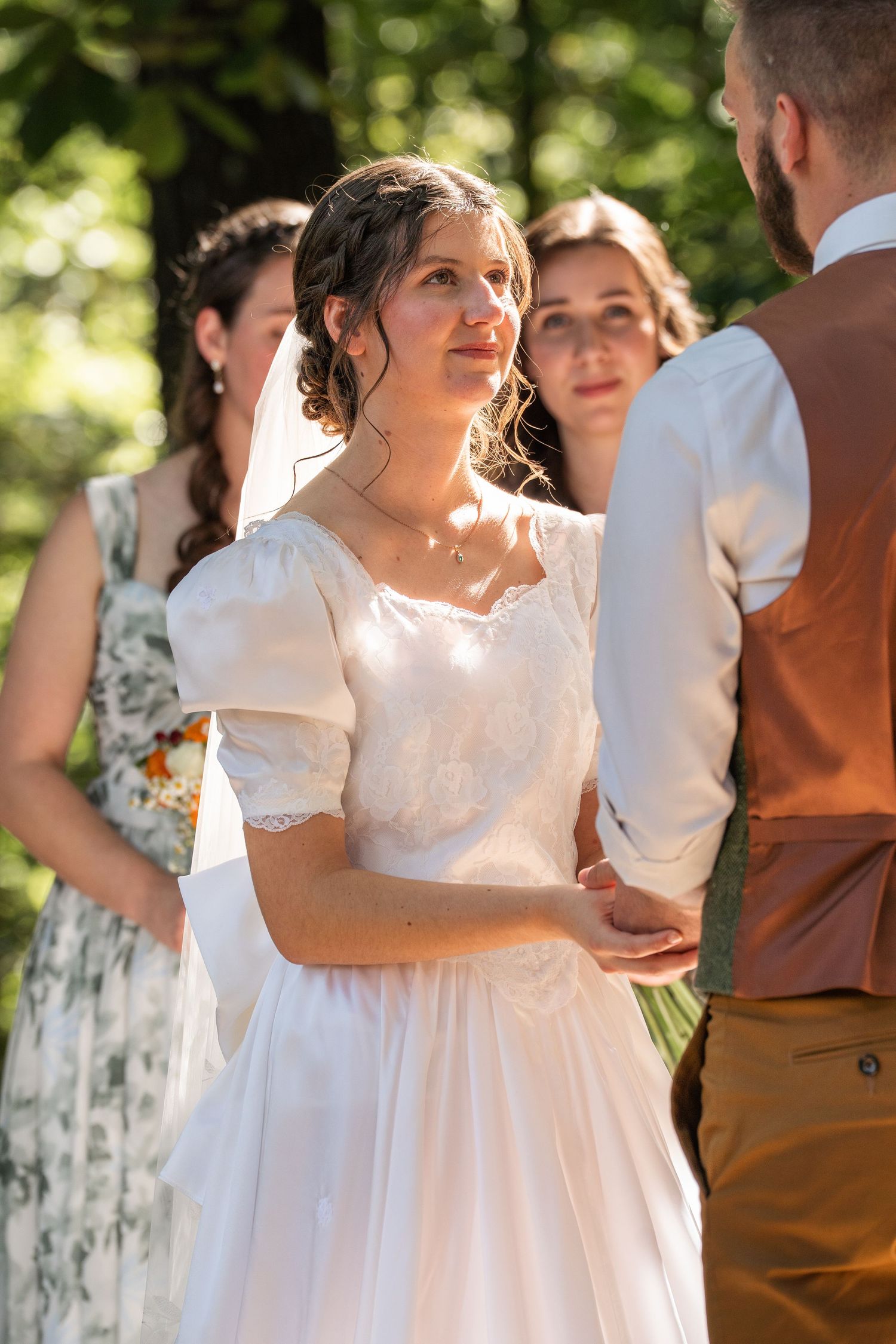 ©AnnaVonRiesenPhotography Wedding Photography | Color image of the bride smiling at her groom during the ceremony.