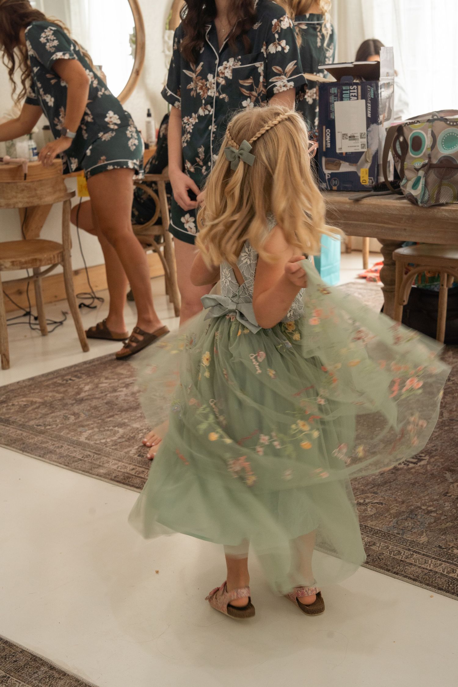 ©AnnaVonRiesenPhotography Wedding Photography | Color image of a flower girl twirling in her dress.