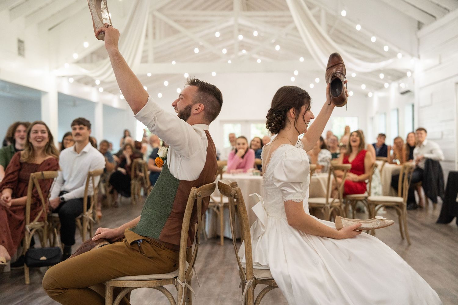 ©AnnaVonRiesenPhotography Wedding Photography | Color image of a bride & groom playing the shoe game.
