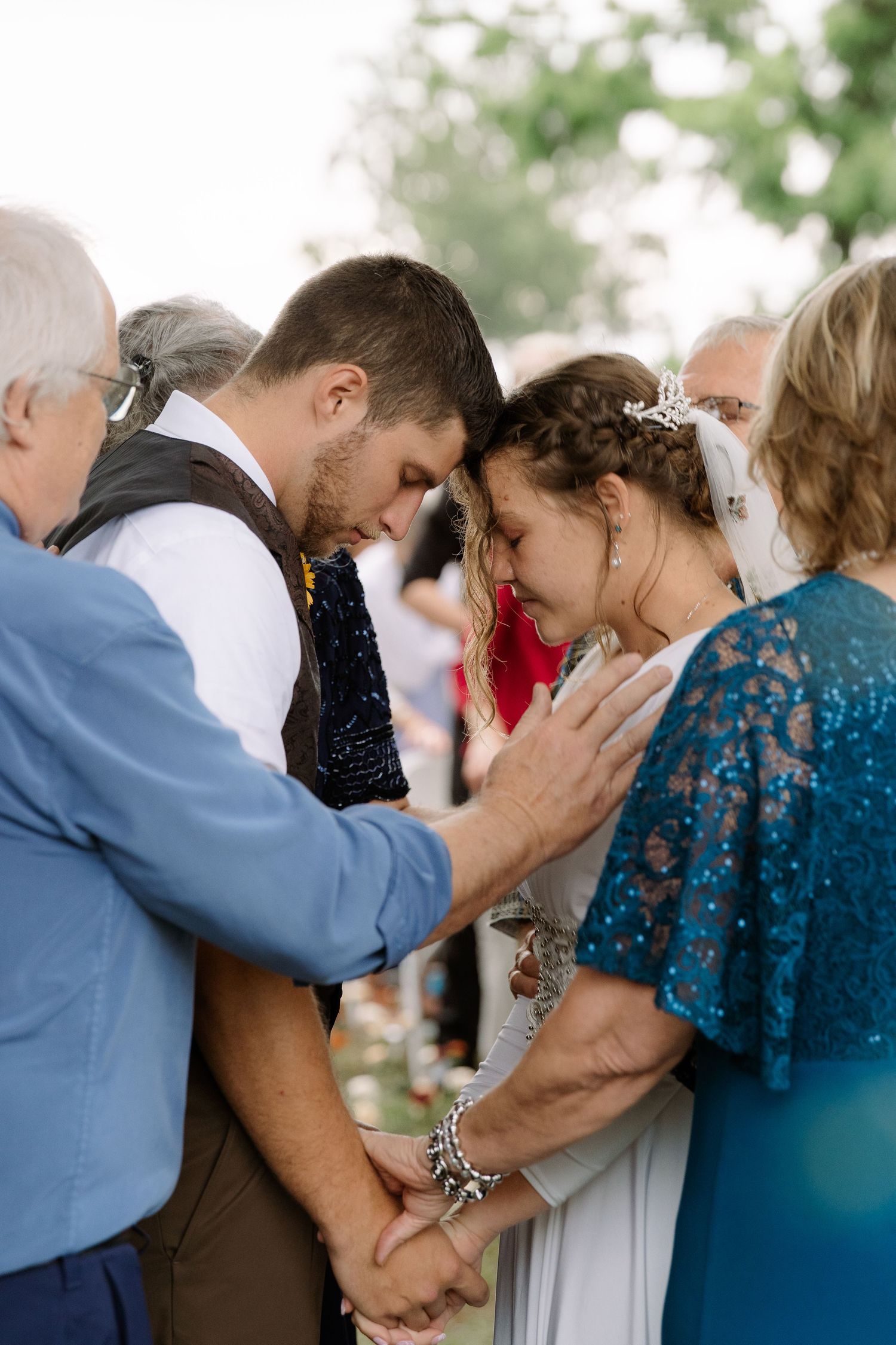 ©AnnaVonRiesenPhotography Wedding Photography | Color image of the parents praying over the bride & groom at the altar.