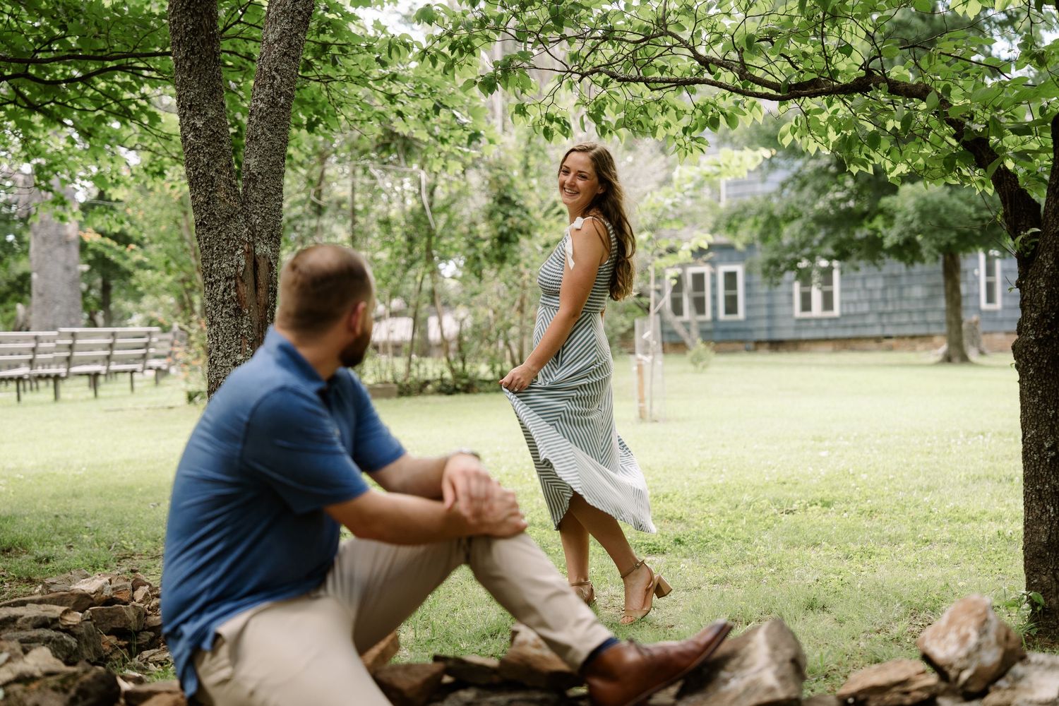 ©AnnaVonRiesenPhotography Engagement Photography | Color image of a woman twirling as her fiancé admires her.