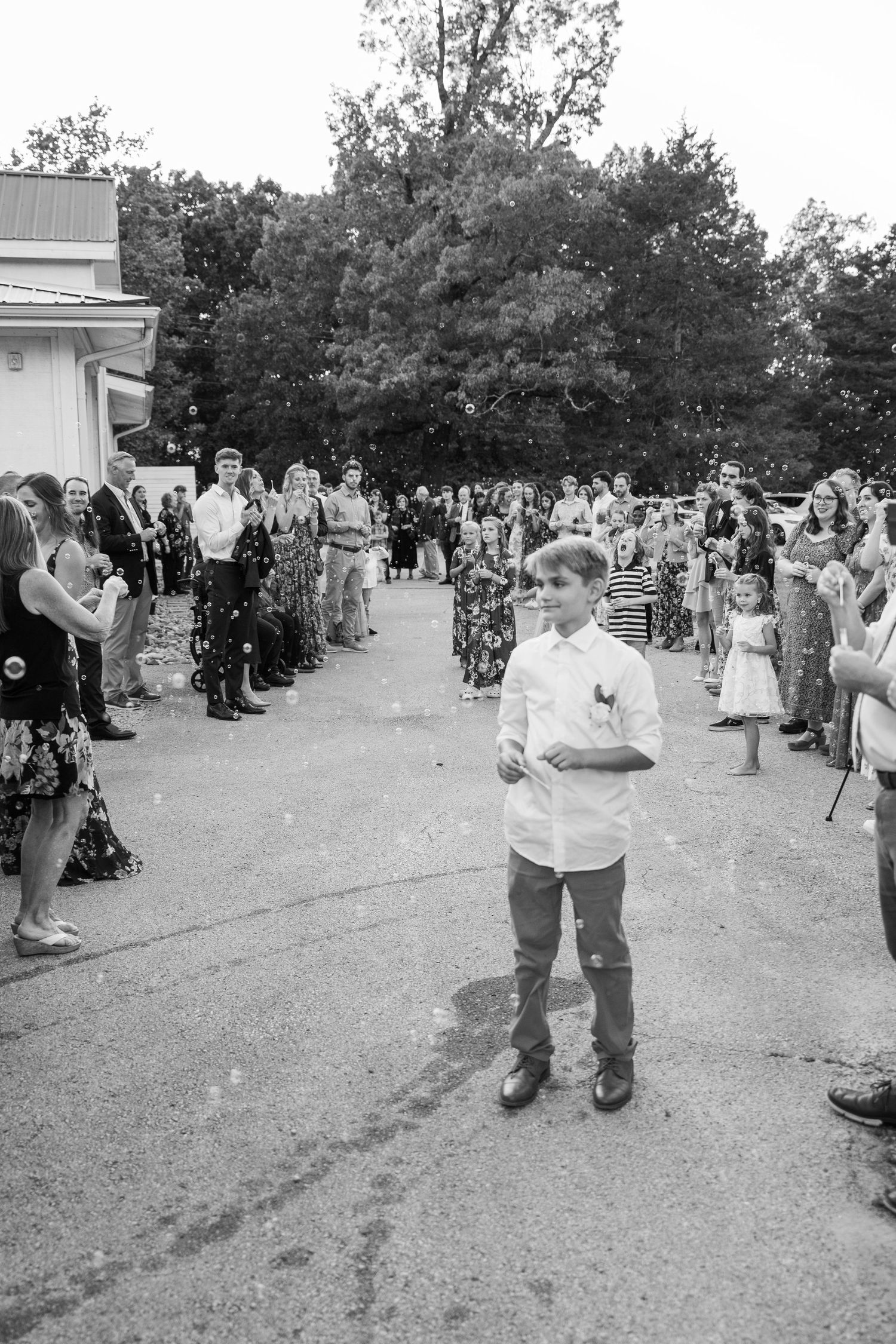 ©AnnaVonRiesenPhotography Wedding Photography | B&W image of wedding guests watching the bride & groom leave.