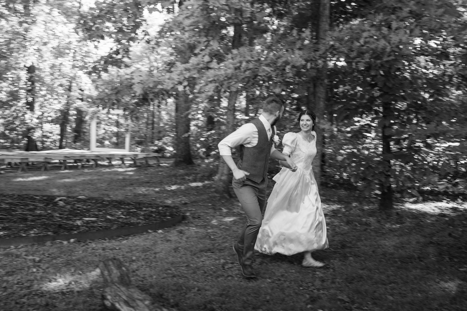 ©AnnaVonRiesenPhotography Wedding Photography | B&W image of the bride & groom running and smiling together.