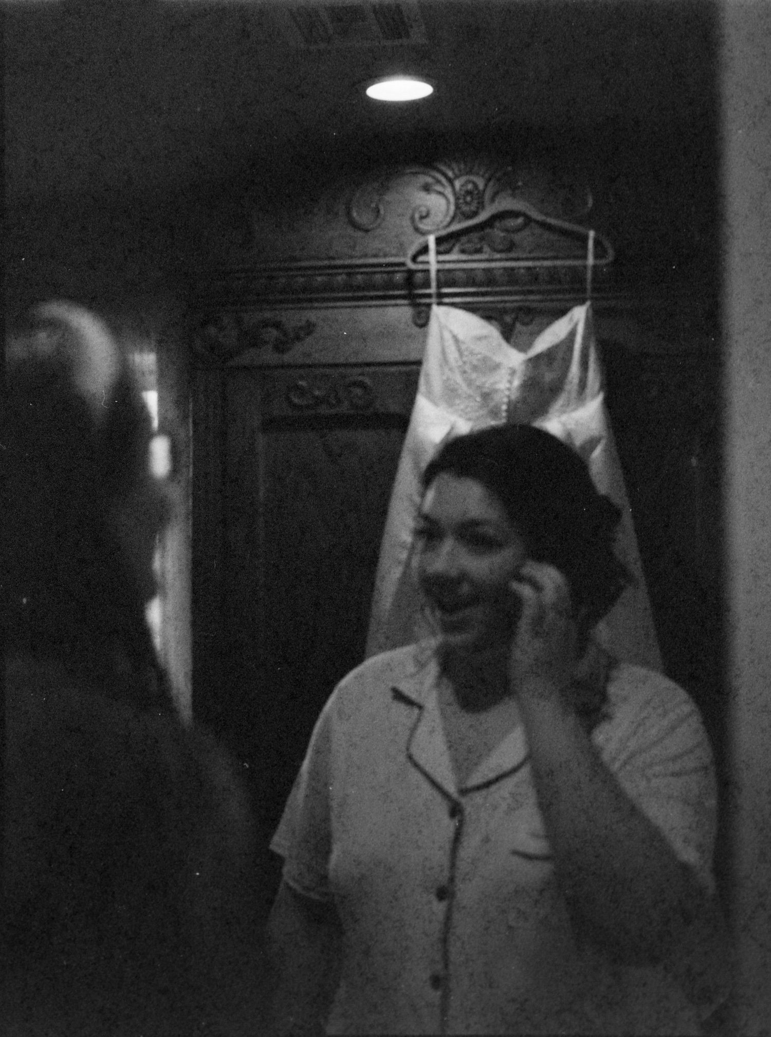 ©AnnaVonRiesenPhotography Wedding Photography | Film B&W image of the bride with her dress hanging behind her.
