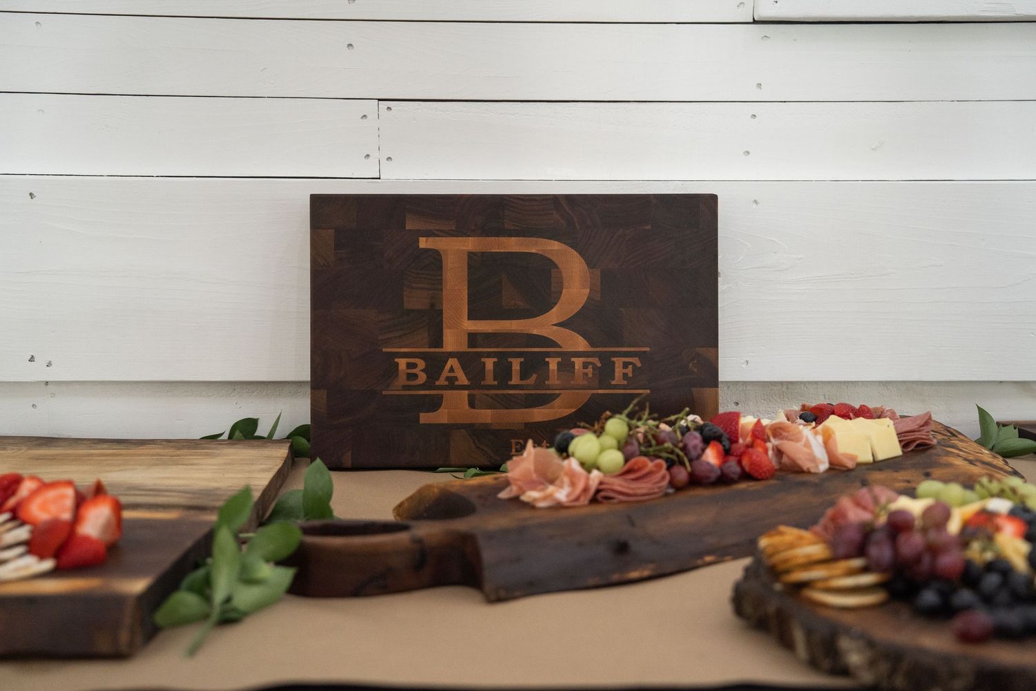 ©AnnaVonRiesenPhotography Wedding Photography | Color image of a custom cutting board on the charcuterie table.