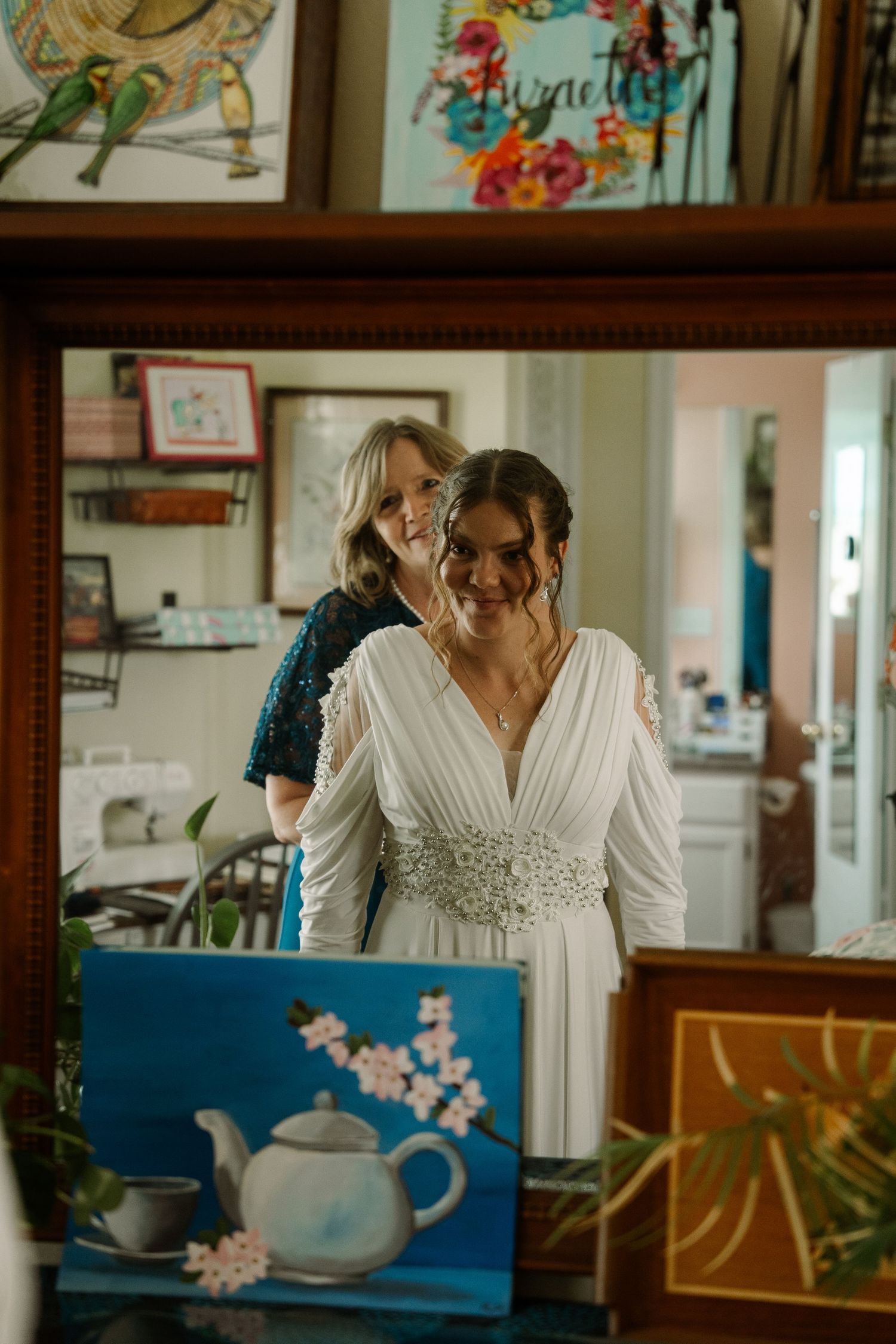 ©AnnaVonRiesenPhotography Wedding Photography | Color image of the bride's mother looking over her daughter's shoulder in the mirror.
