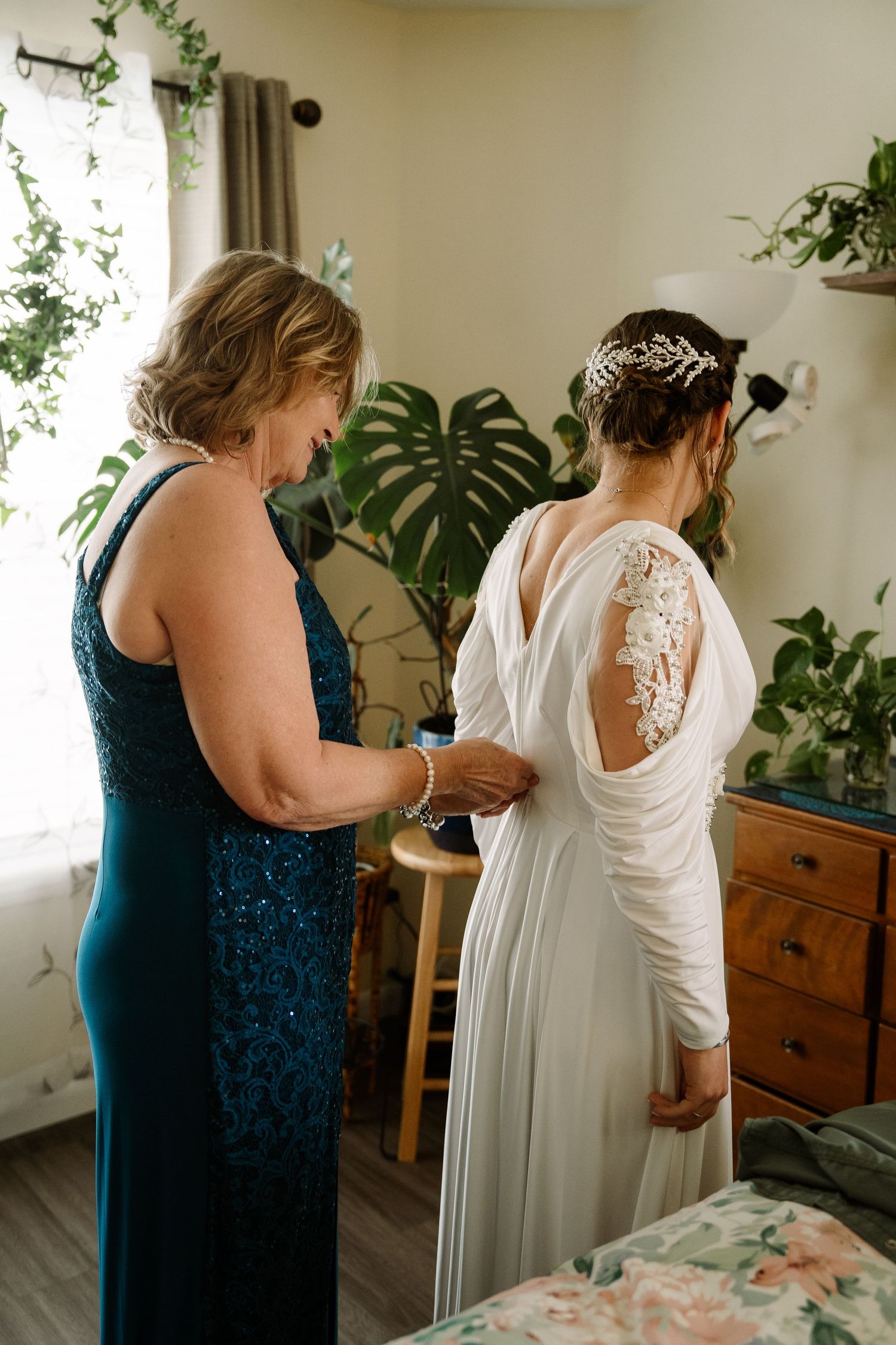 ©AnnaVonRiesenPhotography Wedding Photography | Color image of the bride getting zipped into her dress by her mother.