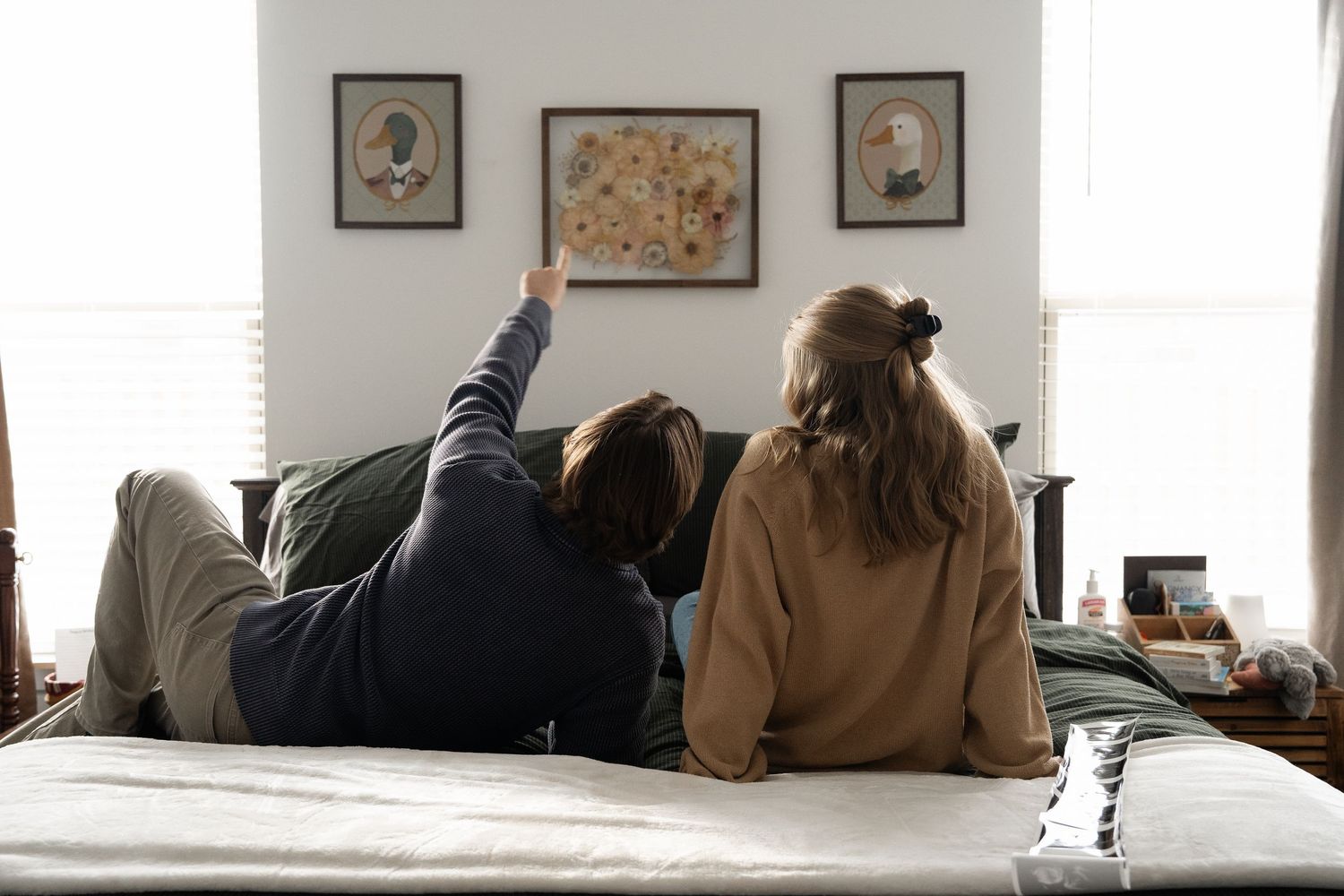 ©AnnaVonRiesenPhotography Couples Photography | Color image of a couple laying on their bed.