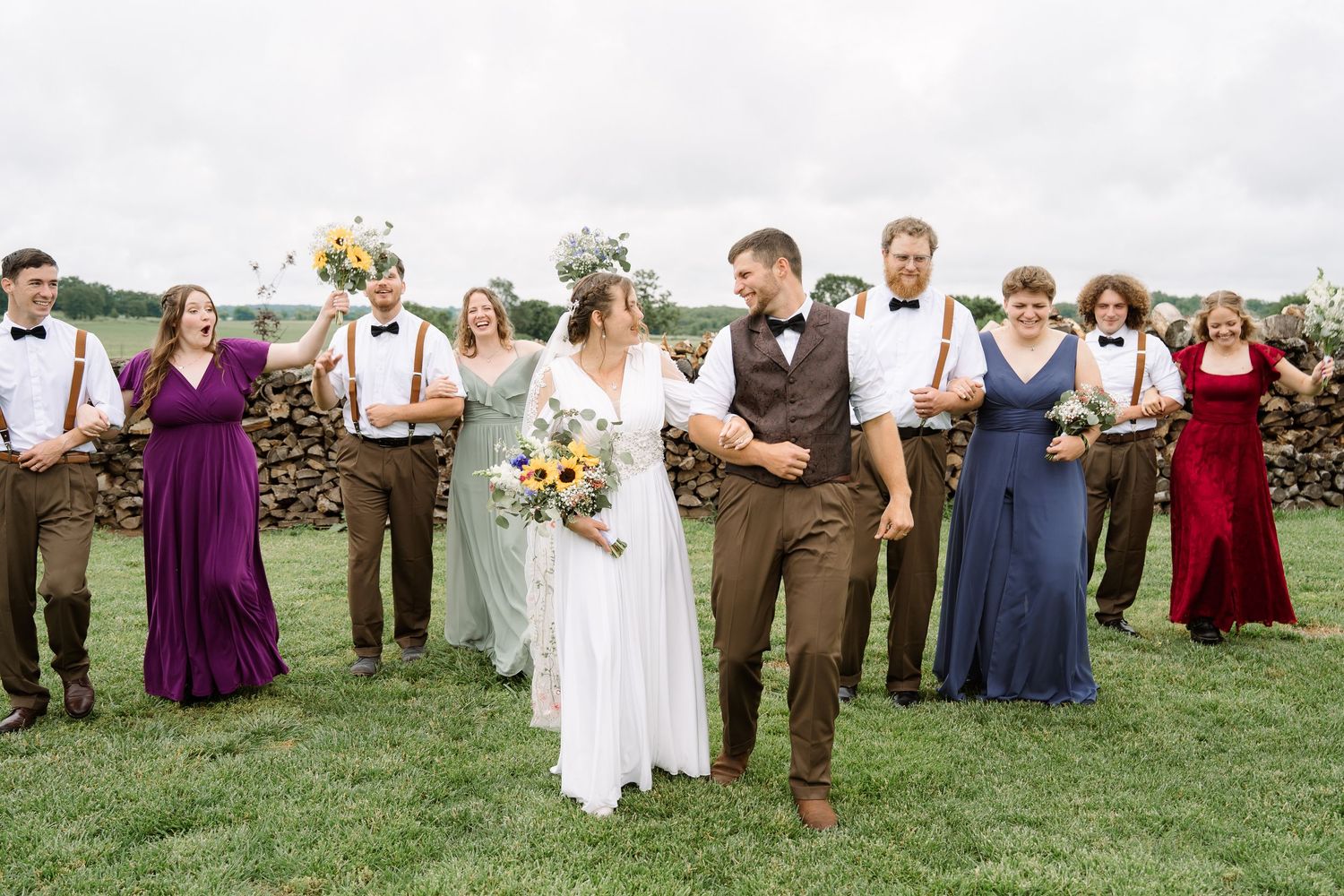 ©AnnaVonRiesenPhotography Wedding Photography | Color image of the bridal party laughing and walking.