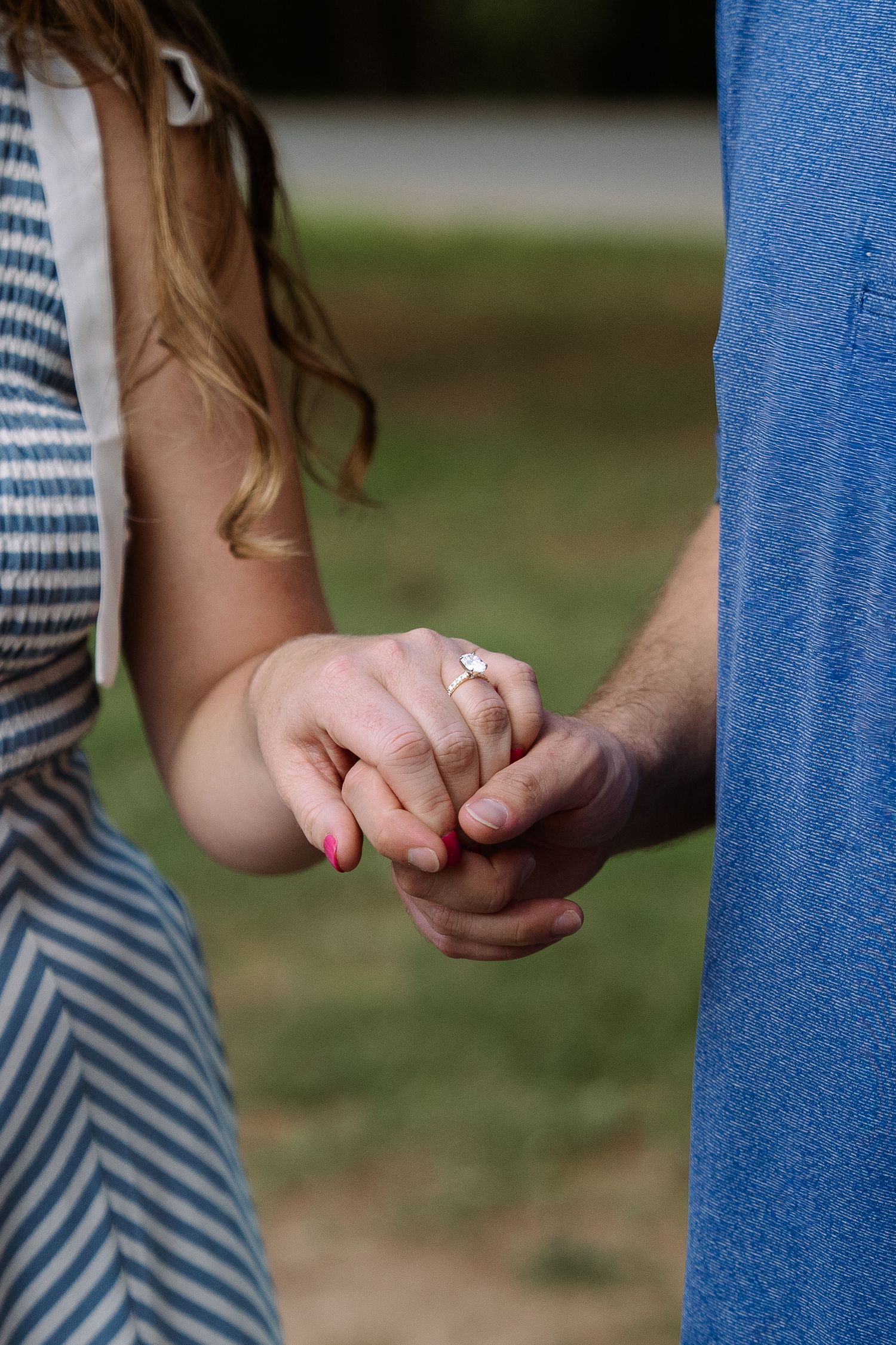 ©AnnaVonRiesenPhotography Engagement Photography | Color image of a man holding his fianceé's hand showing off her ring.