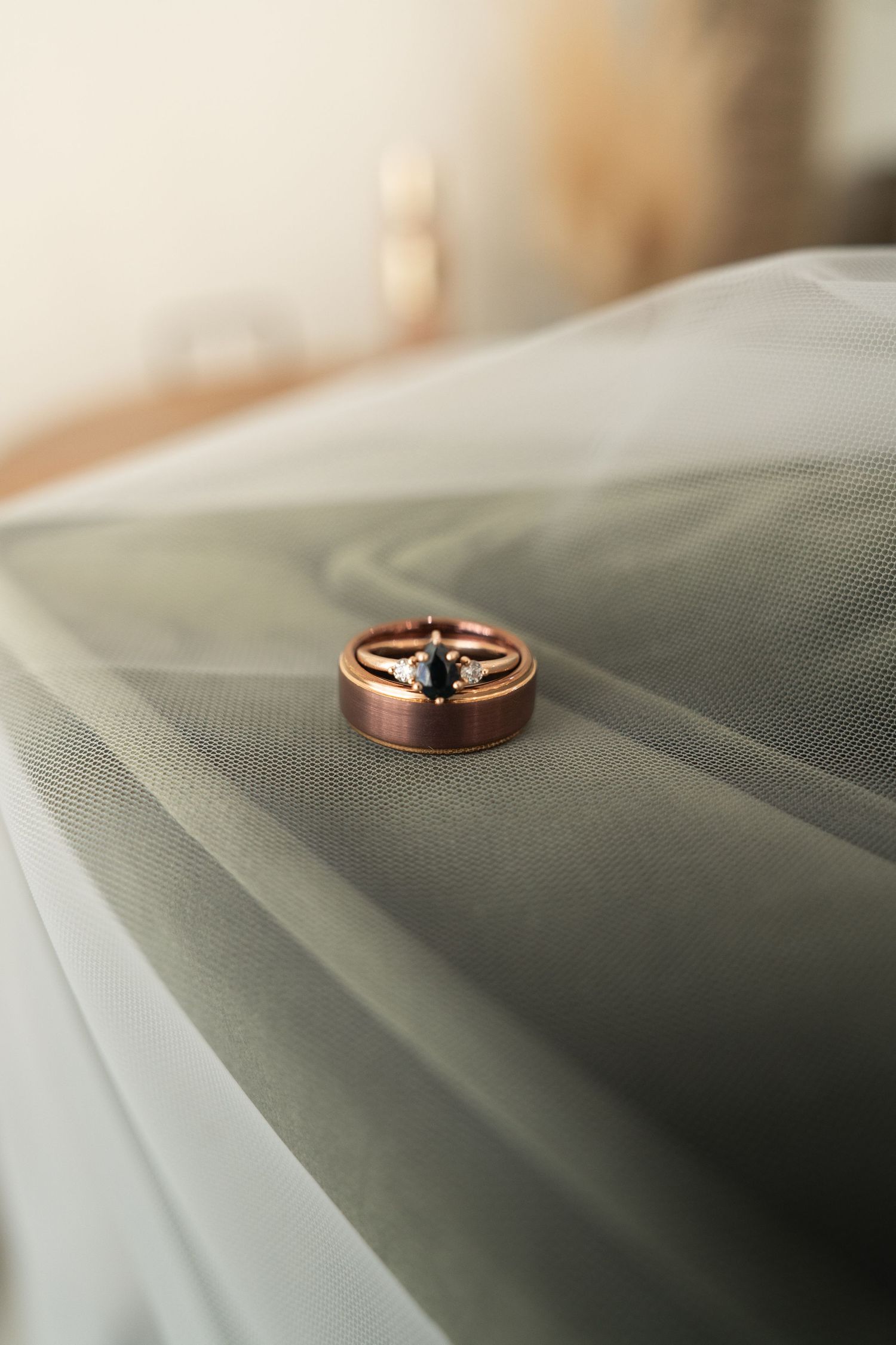 ©AnnaVonRiesenPhotography Wedding Photography | Color image of the rings stacked on top of each other on top of the veil.