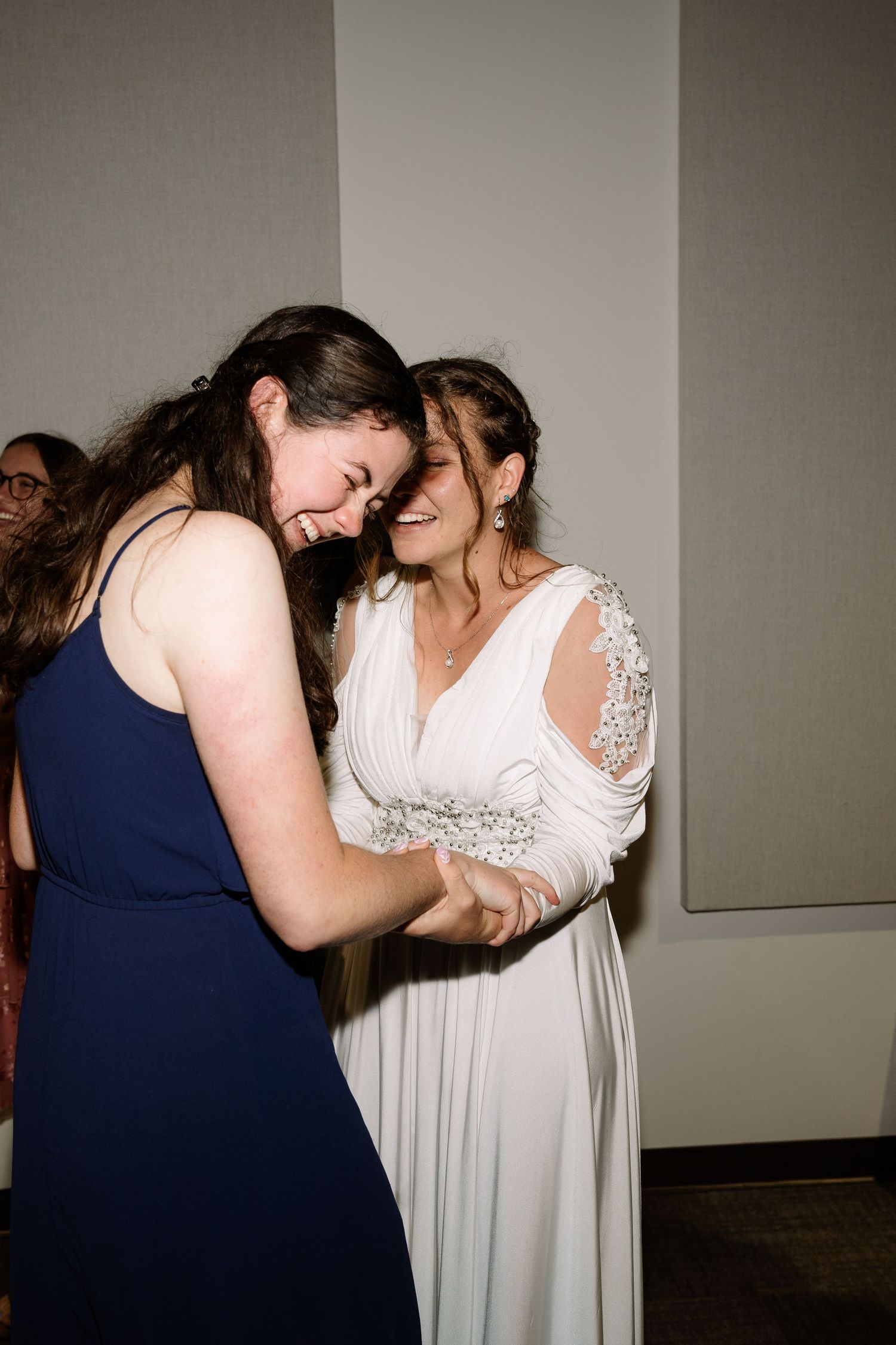 ©AnnaVonRiesenPhotography Wedding Photography | Color image of the bride laughing with one of her guests.