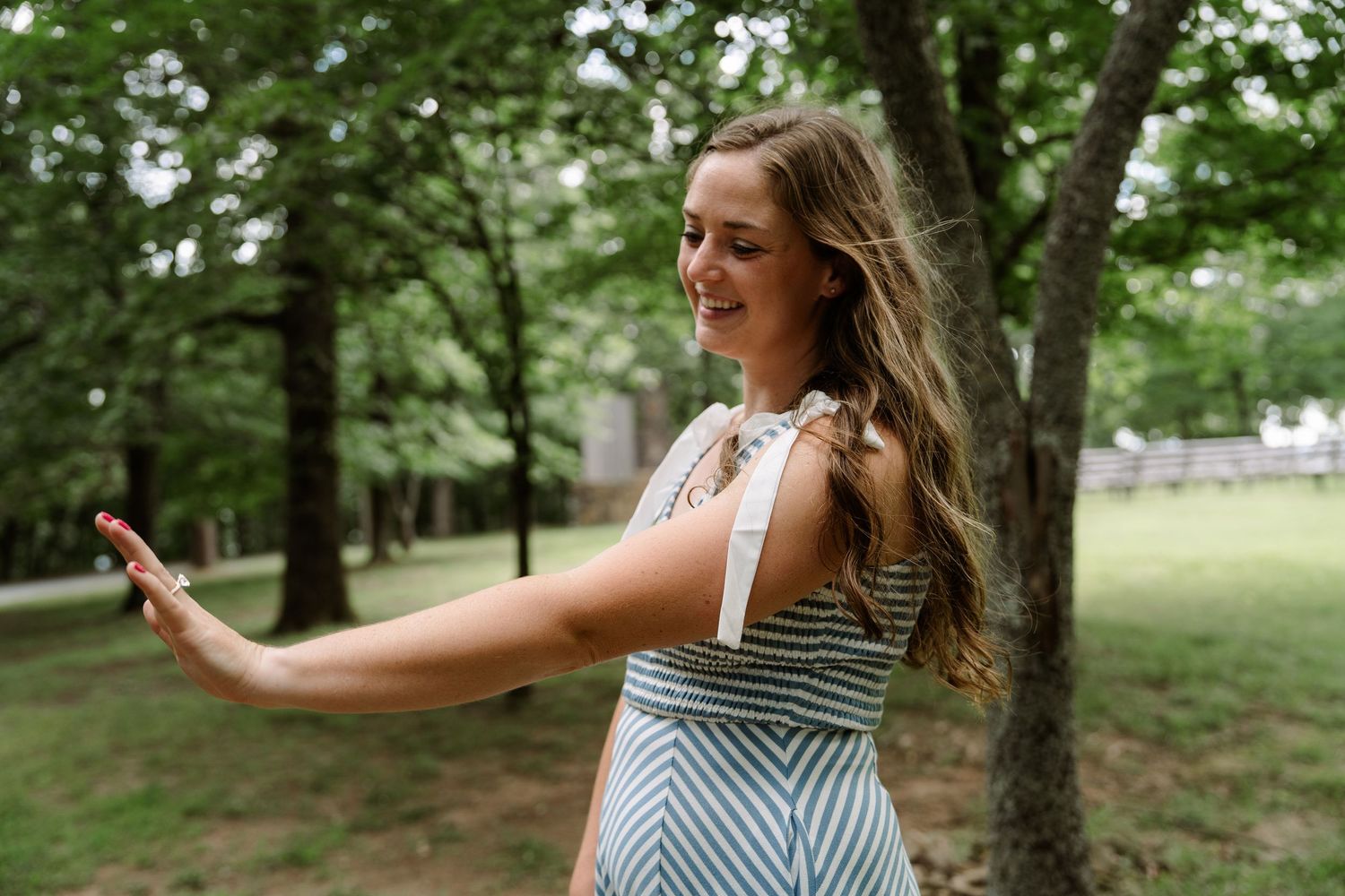 ©AnnaVonRiesenPhotography Engagement Photography | Color image of a woman admiring her new ring.