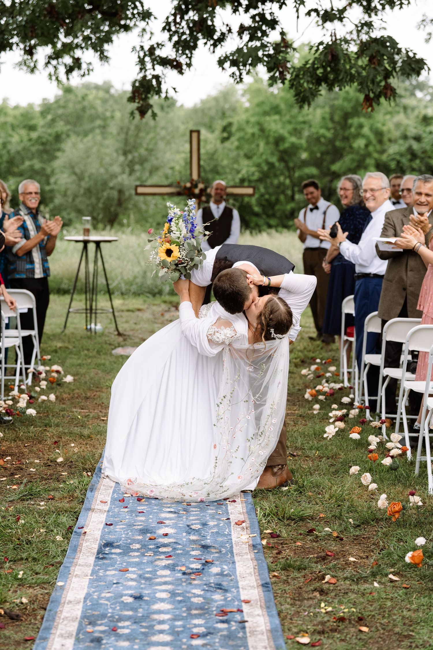©AnnaVonRiesenPhotography Wedding Photography | Color image of the bride & groom dip kissing in the aisle.