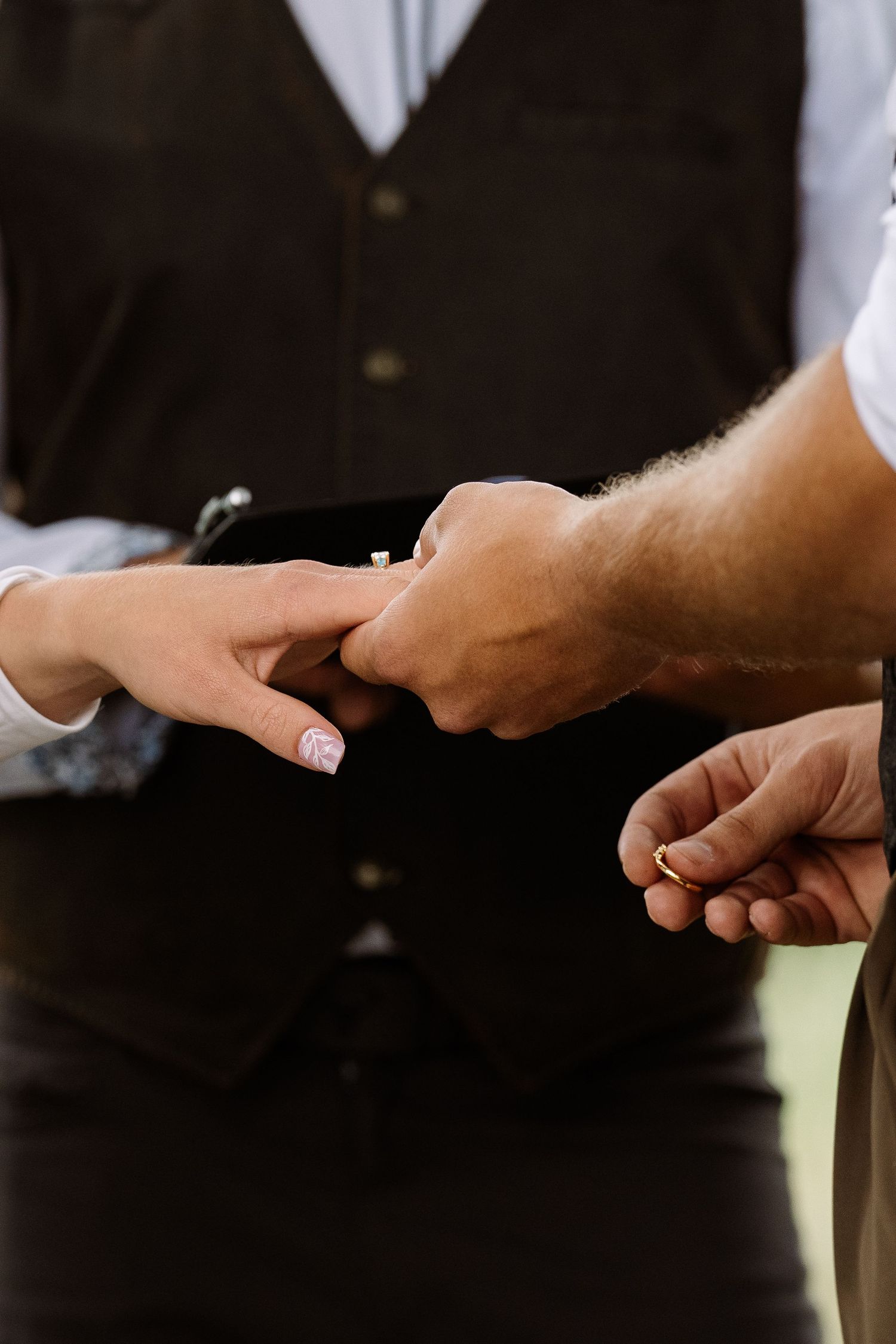 ©AnnaVonRiesenPhotography Wedding Photography |  Color image of the groom placing the ring on the bride.