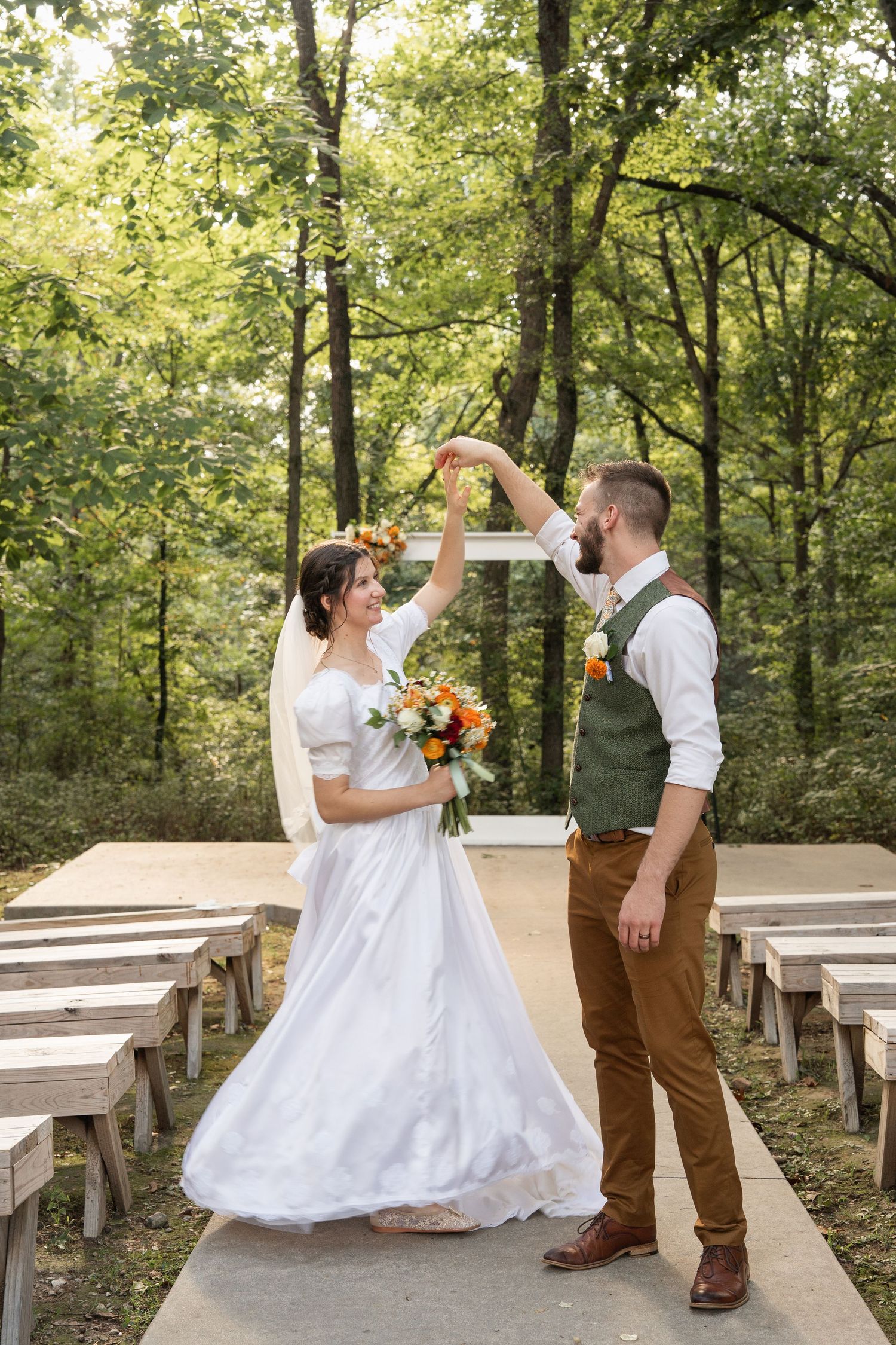 ©AnnaVonRiesenPhotography Wedding Photography | Color image of the groom twirling his bride.